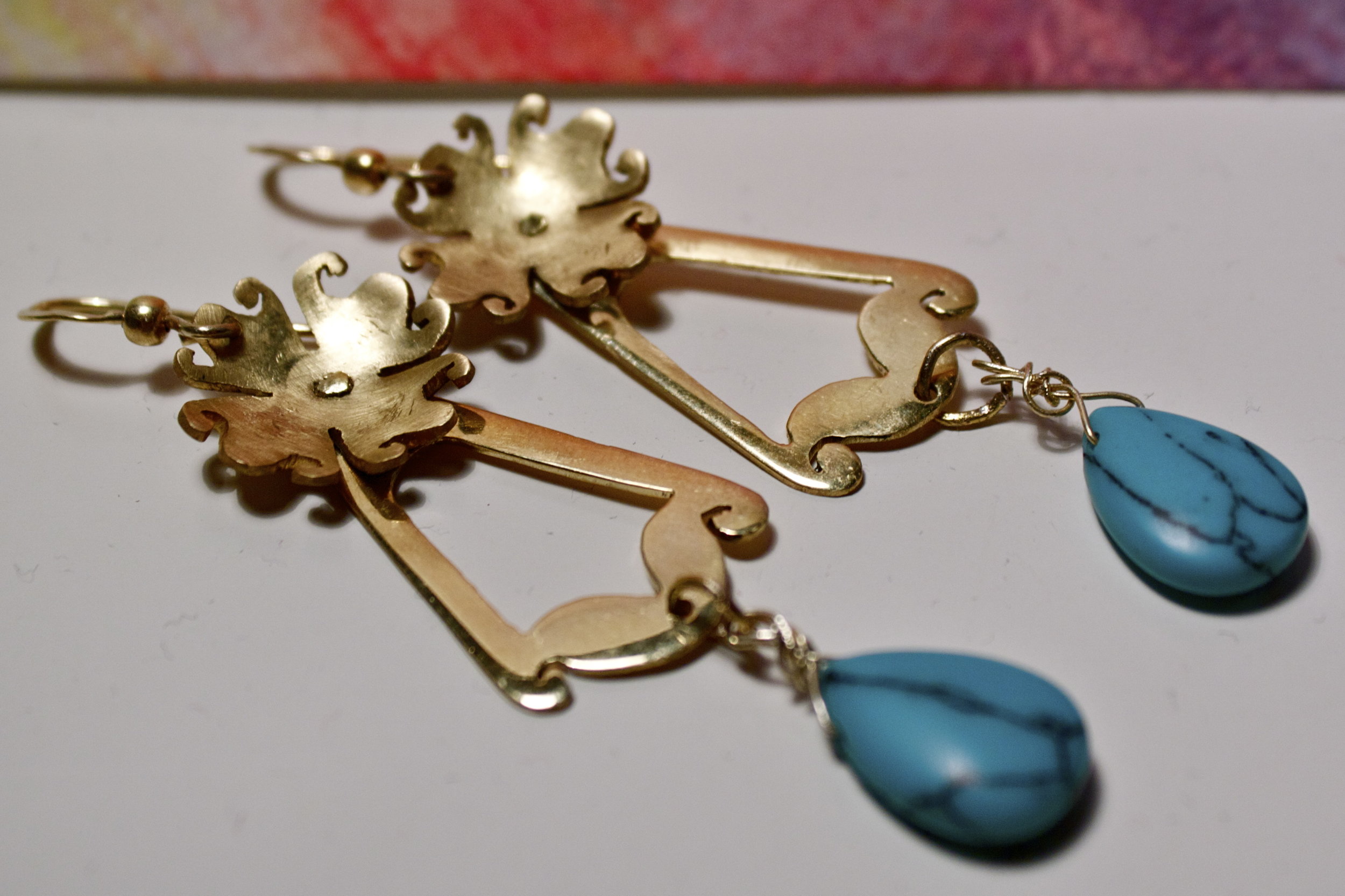 riveted earrings, hand drawn, hand cut, hammered, and polished.