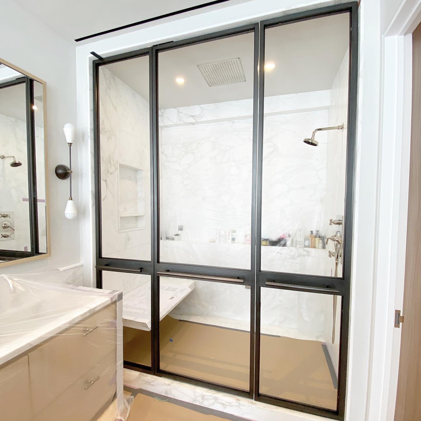 Steam shower partition in all brass. Custom everything from center mount pivot hinge to towel bars and bump stop. Seen here awaiting it&rsquo;s Bendheim Reeded Glass. ...... #brass #frame #brass #towel #bars #shower #partion #showerdesign