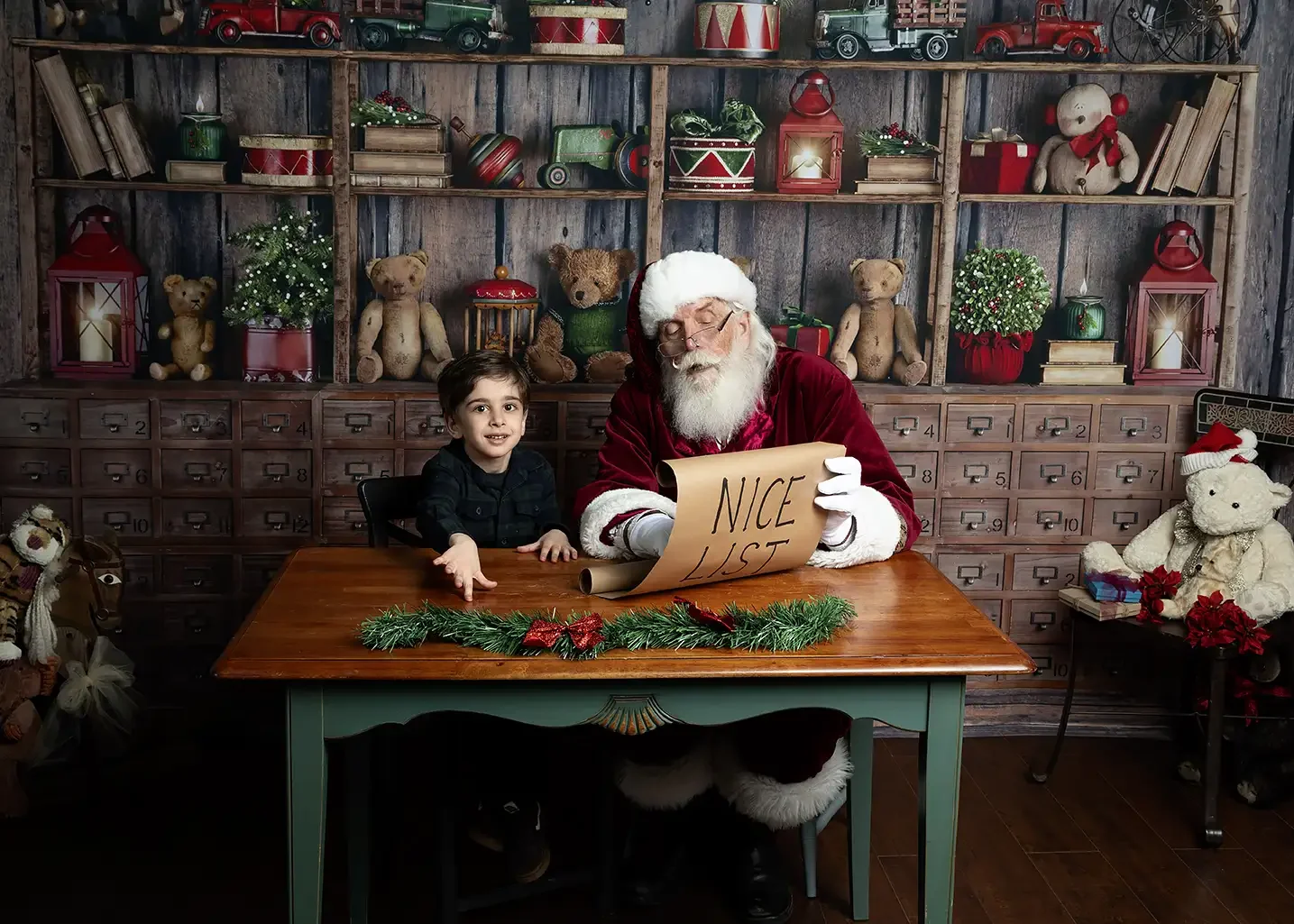 A boy is happy seeing his name on Santa's Nice list during Santa Photos in Glendale