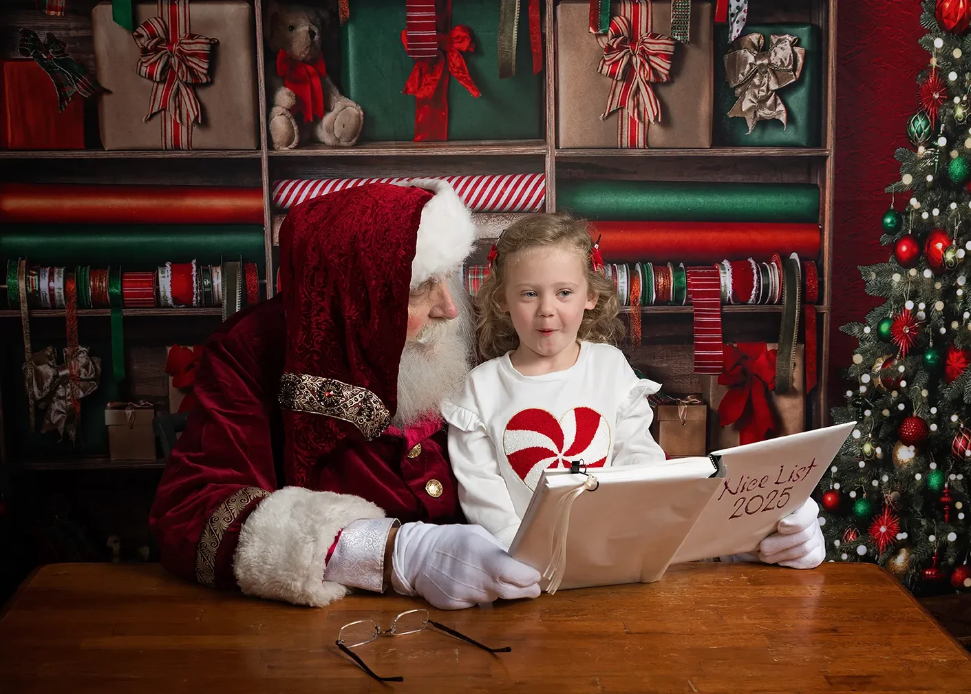 A child see her name on the Nice List with Santa in Glendale