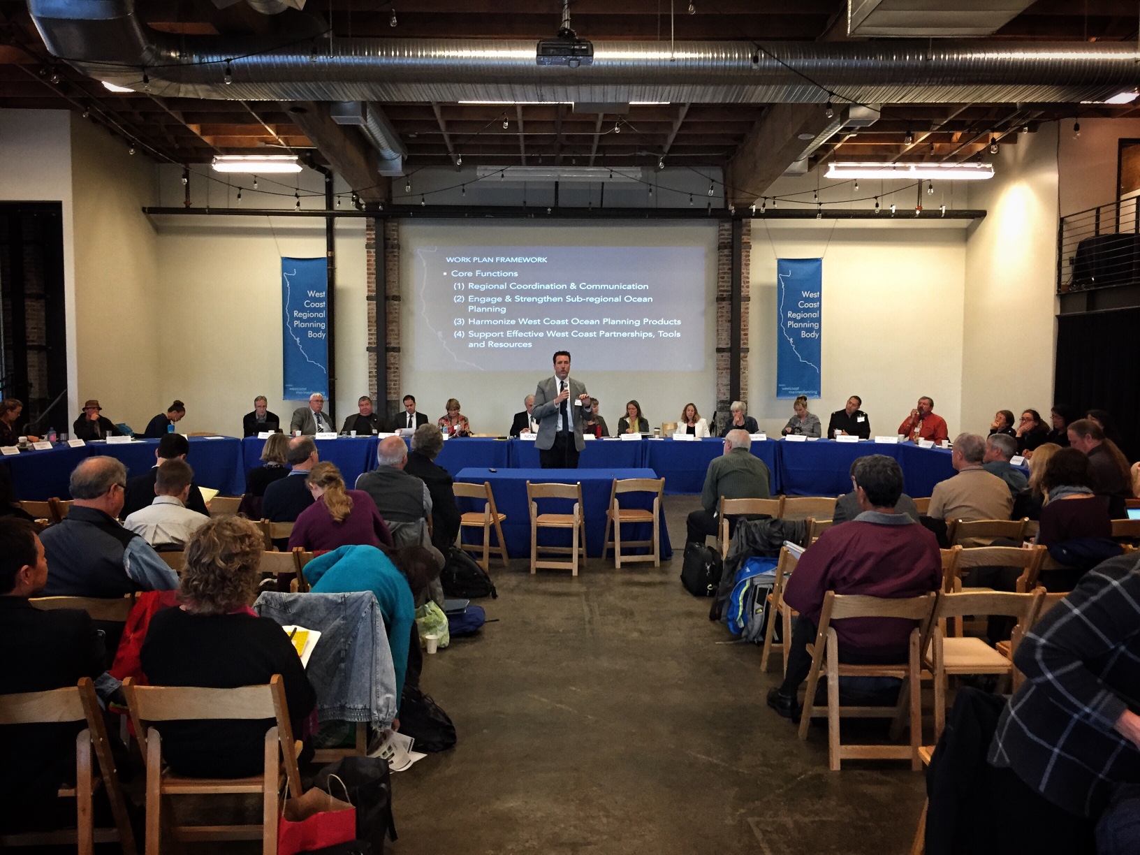 John Hansen, marine planning coordinator, addresses attendees at the west coast regional planning body meeting, Portland, OR. The WCRPB is seated behind him. 