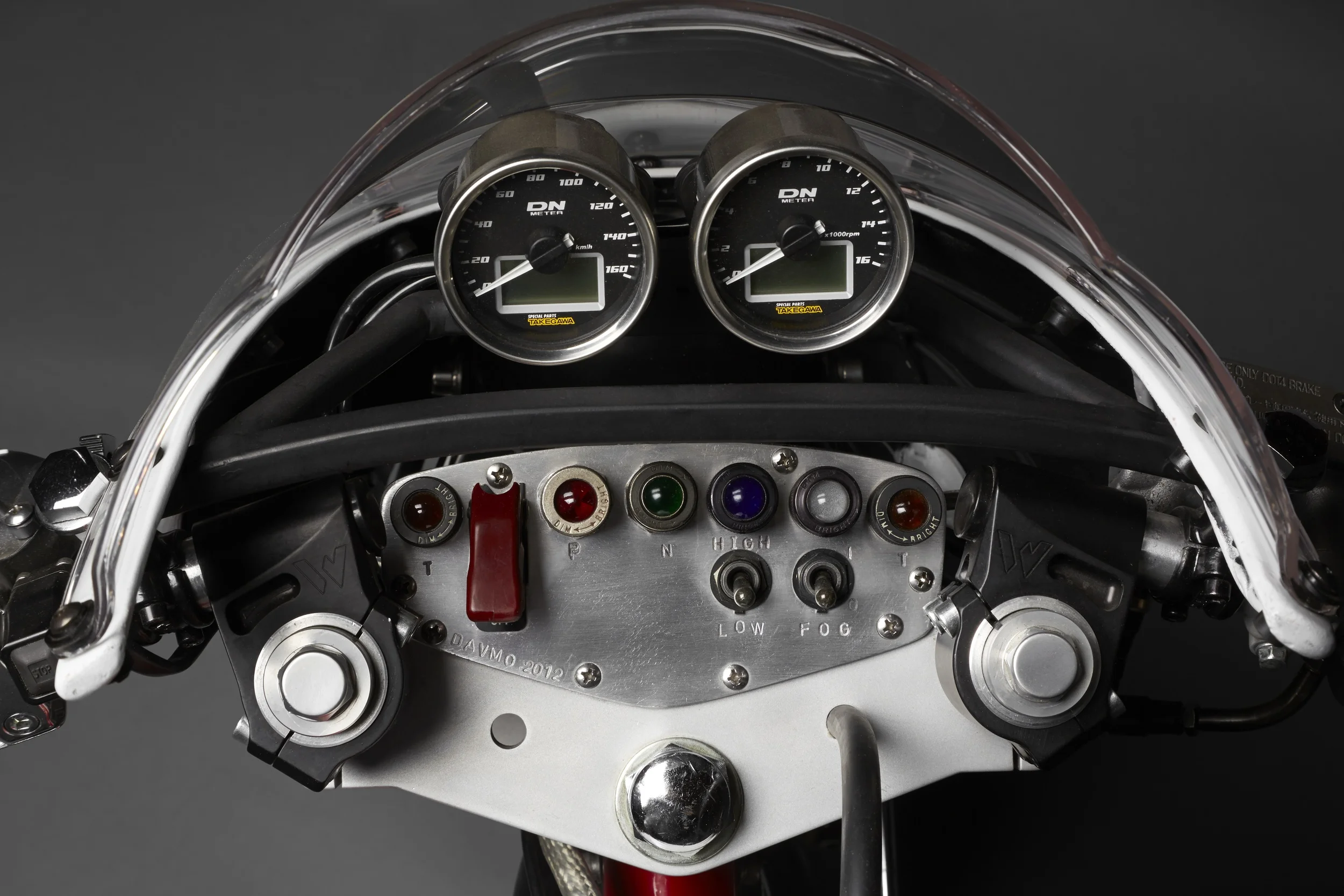 Takegawa speedo and tachometer. The control panel uses dimmable World War 2 era aviation instrument lights and switch flip cover. C&K toggle switches.