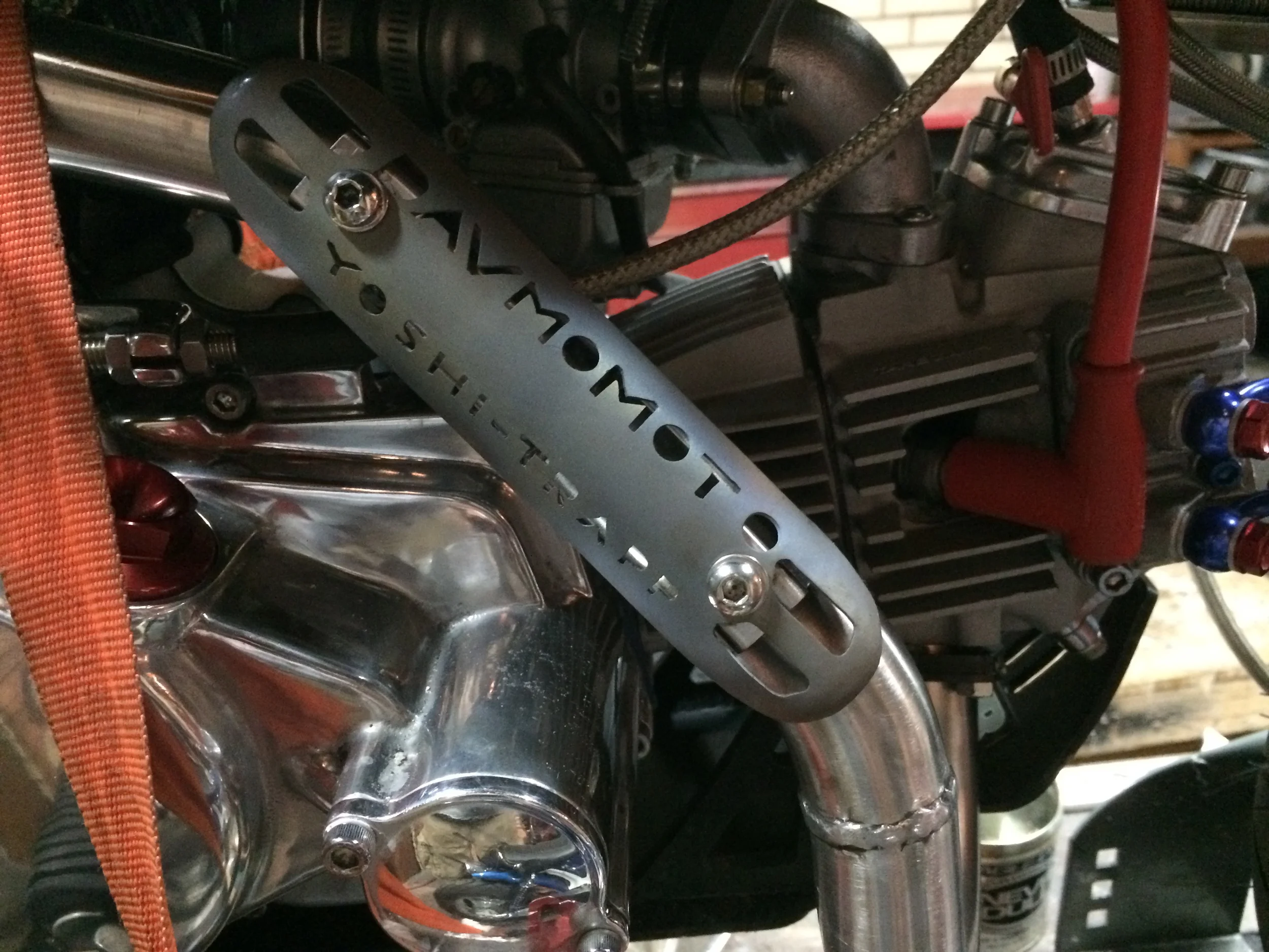 The exhaust header is a Yoshimura for a BBR V3 bike, mated to a Supertrapp muffler. Hence the "Yoshi-Trapp." moniker. My buddies Ross and Chad had me do custom pipes on some of their bikes, and the exhaust heat shield was made from the leftovers from Chad's shortened muffler, while the Yoshi pipe was payment for the work done on Ross's pipe. The pipe was shortened in the first segment 2", and the tail was cut and realigned.