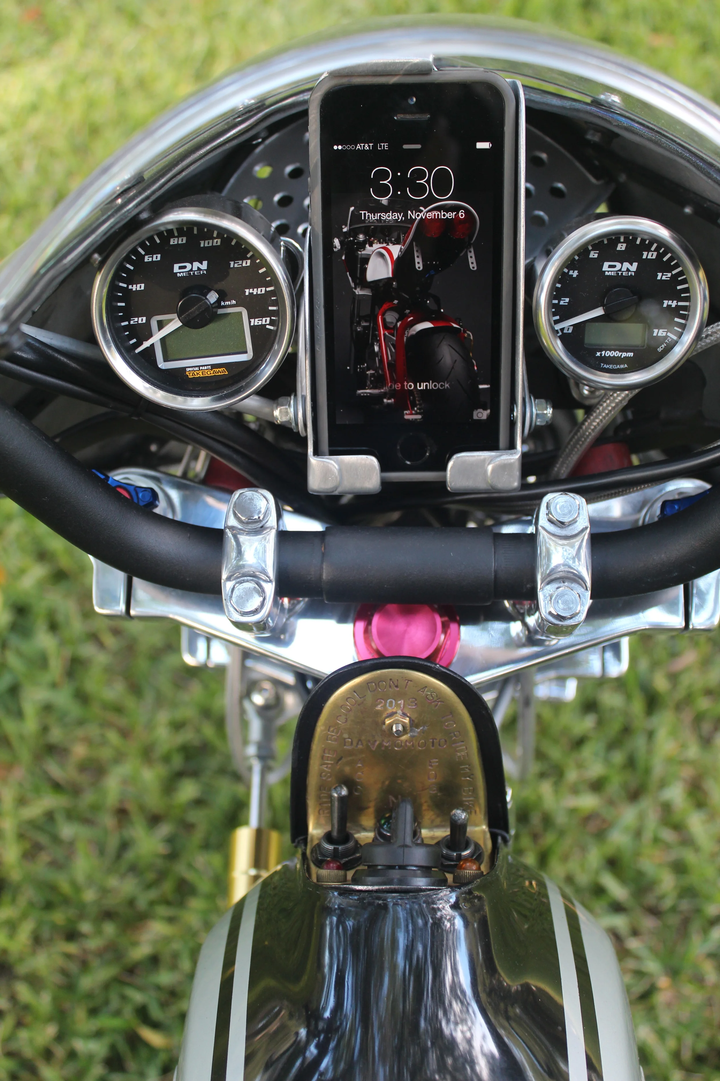 Takegawa speedo and tach, and a custom phone holder. The fold-out contol panel can be seen in the open position.