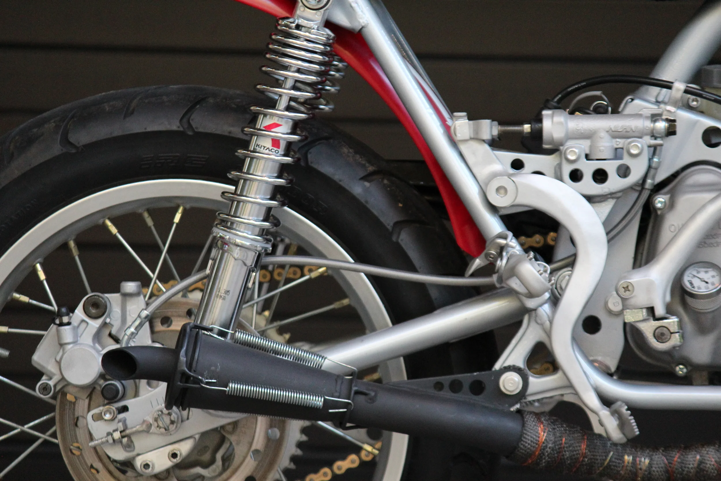  Custom exhaust with removable baffle. The CR80 rear brake master and pedal were used. 