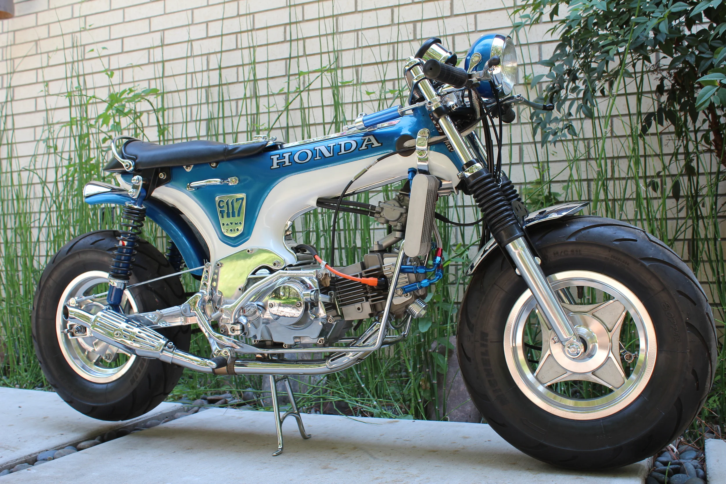 A custom engine cradle with integrated rear-set peg mounts and a custom center stand. A ring at the top of the cradle is the mount for the velocity stack, and there is an oil cooler mount as well. An effort to consolidate some of the lines of the bi