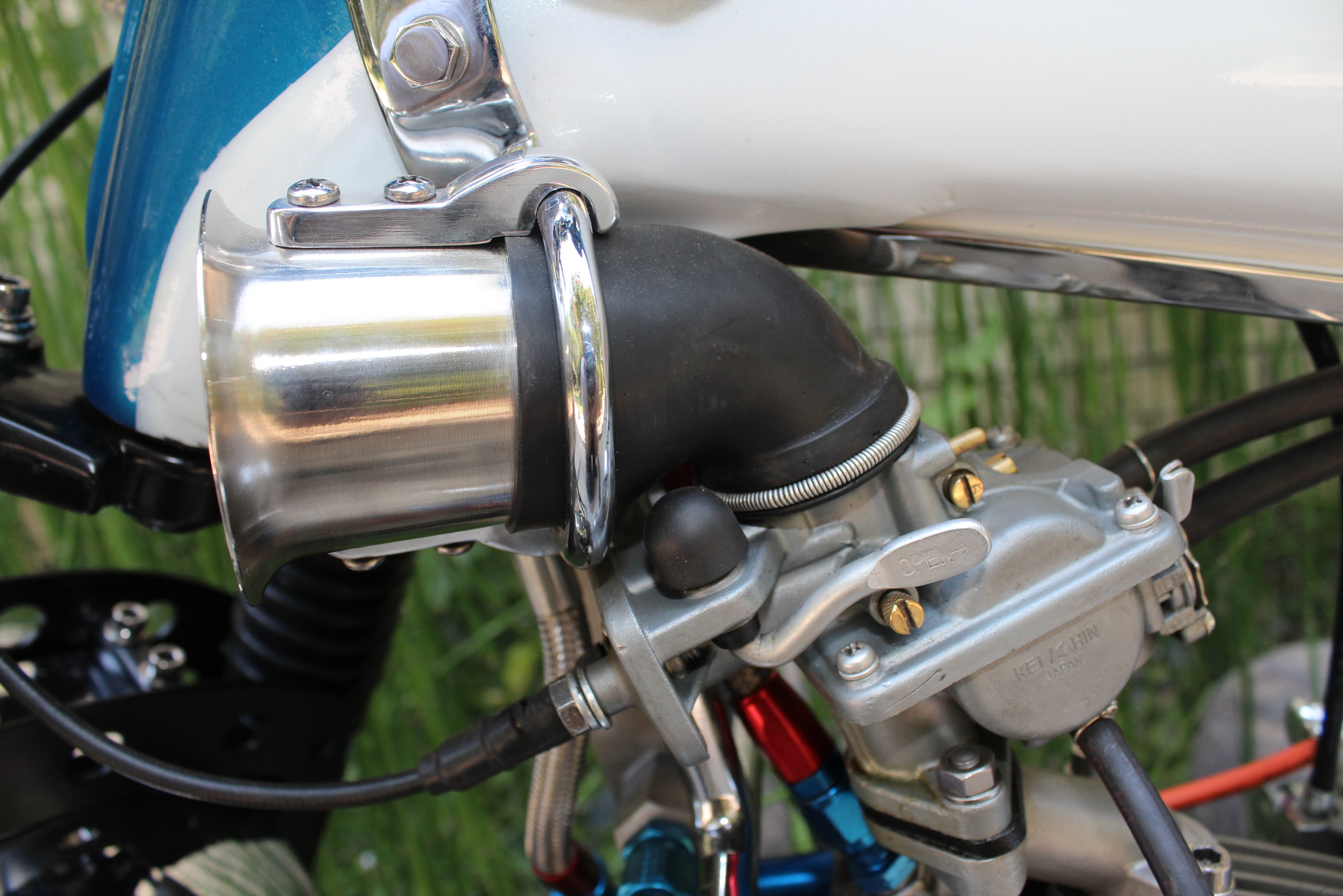   CT90 Keihin down-draft carb with a velocity stack from a Weber carb. 