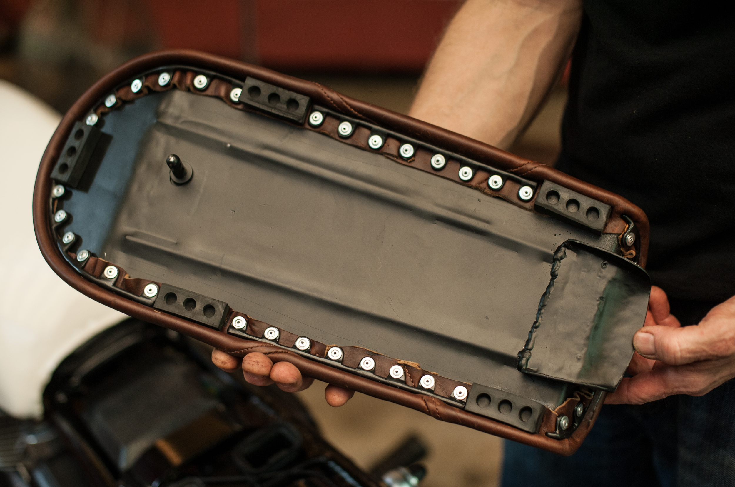With the beautiful saddle cover fashioned by Bell and Oak Leather Studio, and the removable nature of the seat, a quality mounting system seemed in order. The usual washers and rivets were used along with some small welded brackets, to achieve a really clean look.