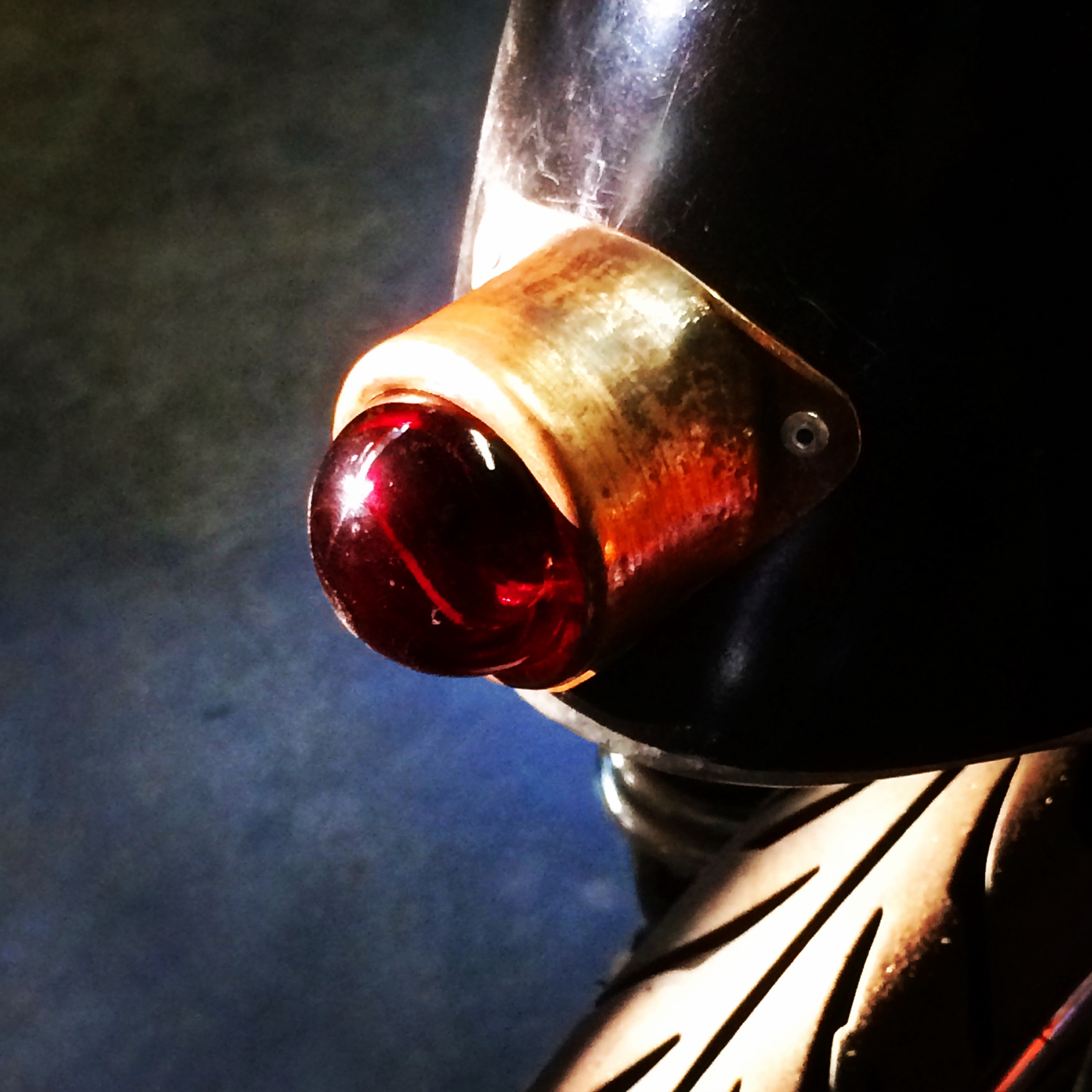 Tail light using a lens from a WW2 era naval aircraft, and bronze from a crash cymbal.