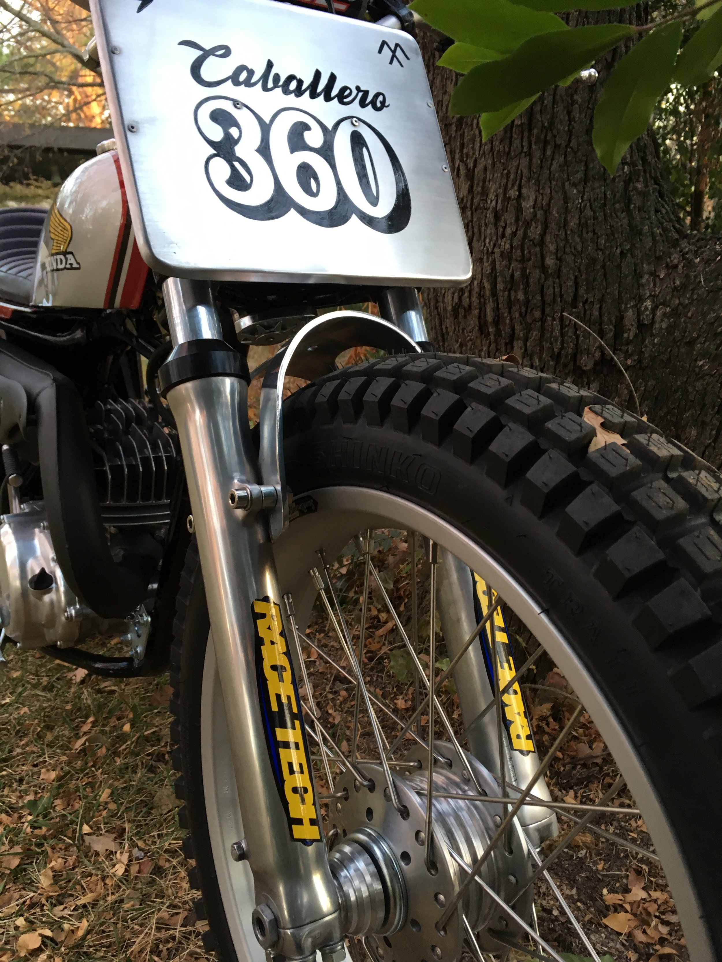  MT250 shortened forks with Racetech progressive springs and Gold Valve Emulators. Since there is no front brake, the rotor boss on the front hub was shaved down. A vintage Cal Custom fork brace was used. 