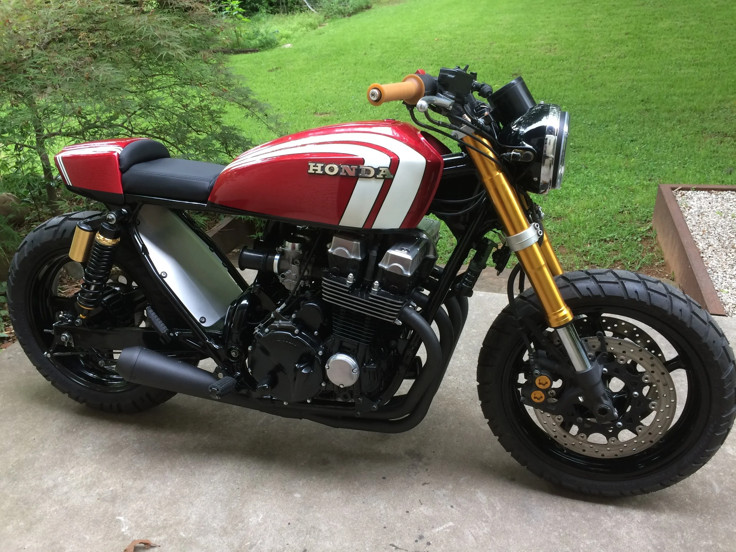   A 1993 Honda CB750 Nighthawk custom. Referred to as a “convertible” because of a special feature allowing the seat to be lengthened from a solo seat to one long enough to take a passenger along. The entire rear frame was rebuilt and a custom seat a