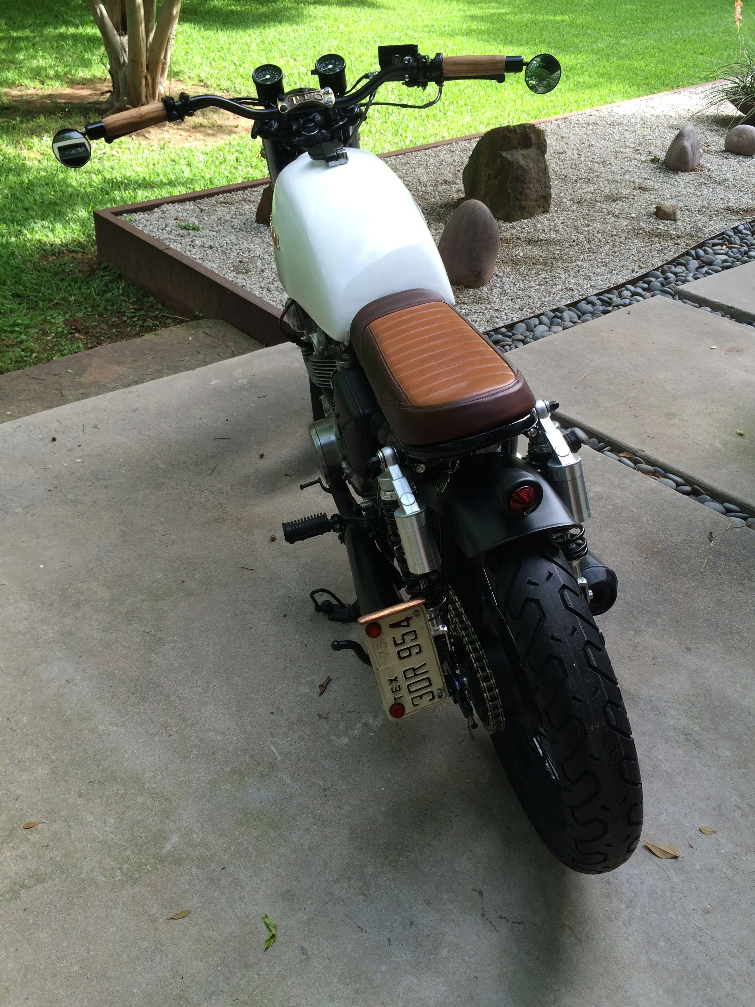  The rear was shortened and a loop grafted in. There are small Supernova LED signals hidden beneath the seat. The seatcover was custom made from two shades of Horween leather by Clint Wilkinson of Wilkinson, TX. here in Denton. 