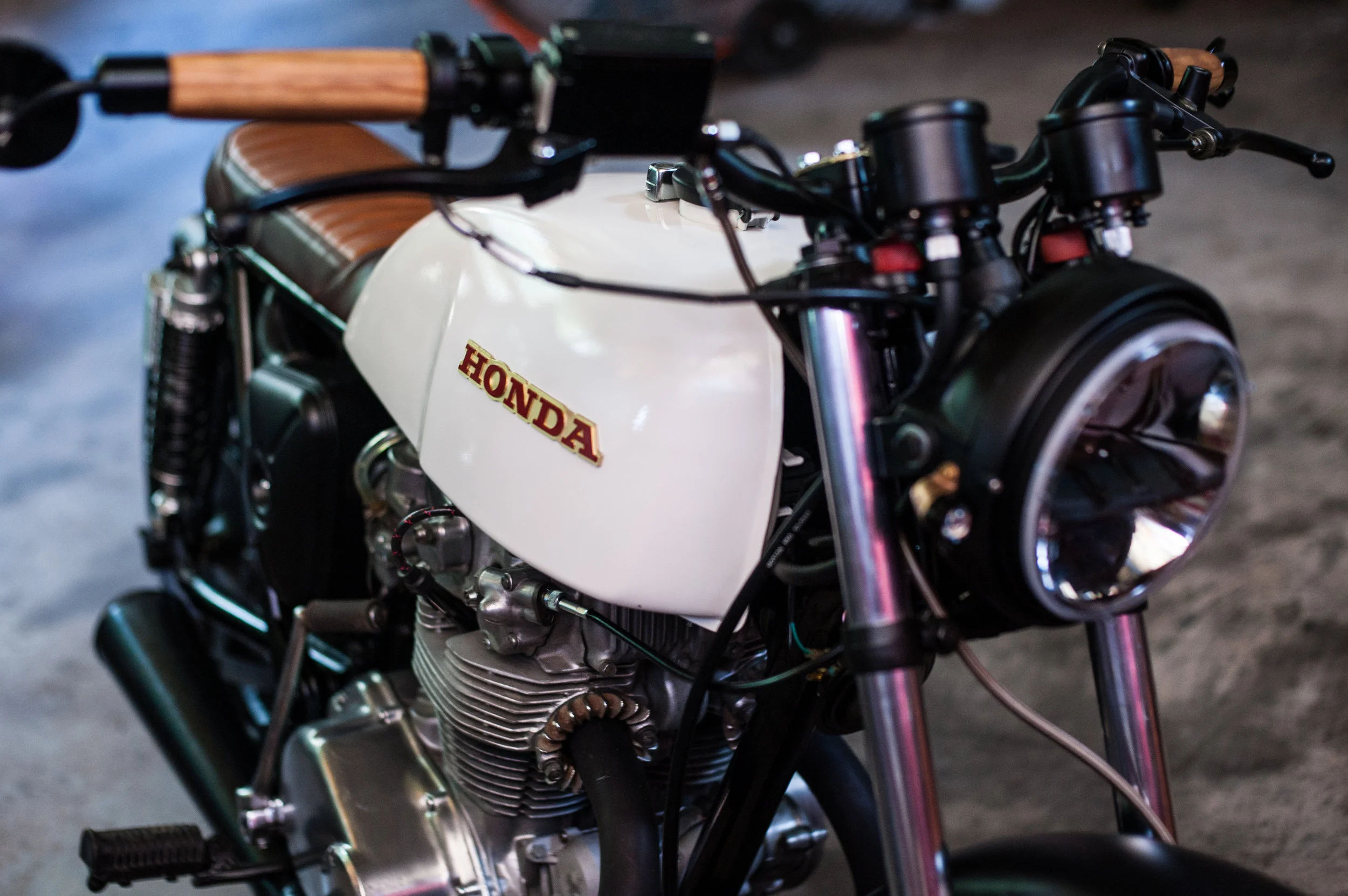Tiny Supernova LED turn signals on the side of the headlight bucket. The mounts for the signals are made from bronze harvested from a broken cymbal. The rear license plate light is made from the same bronze.