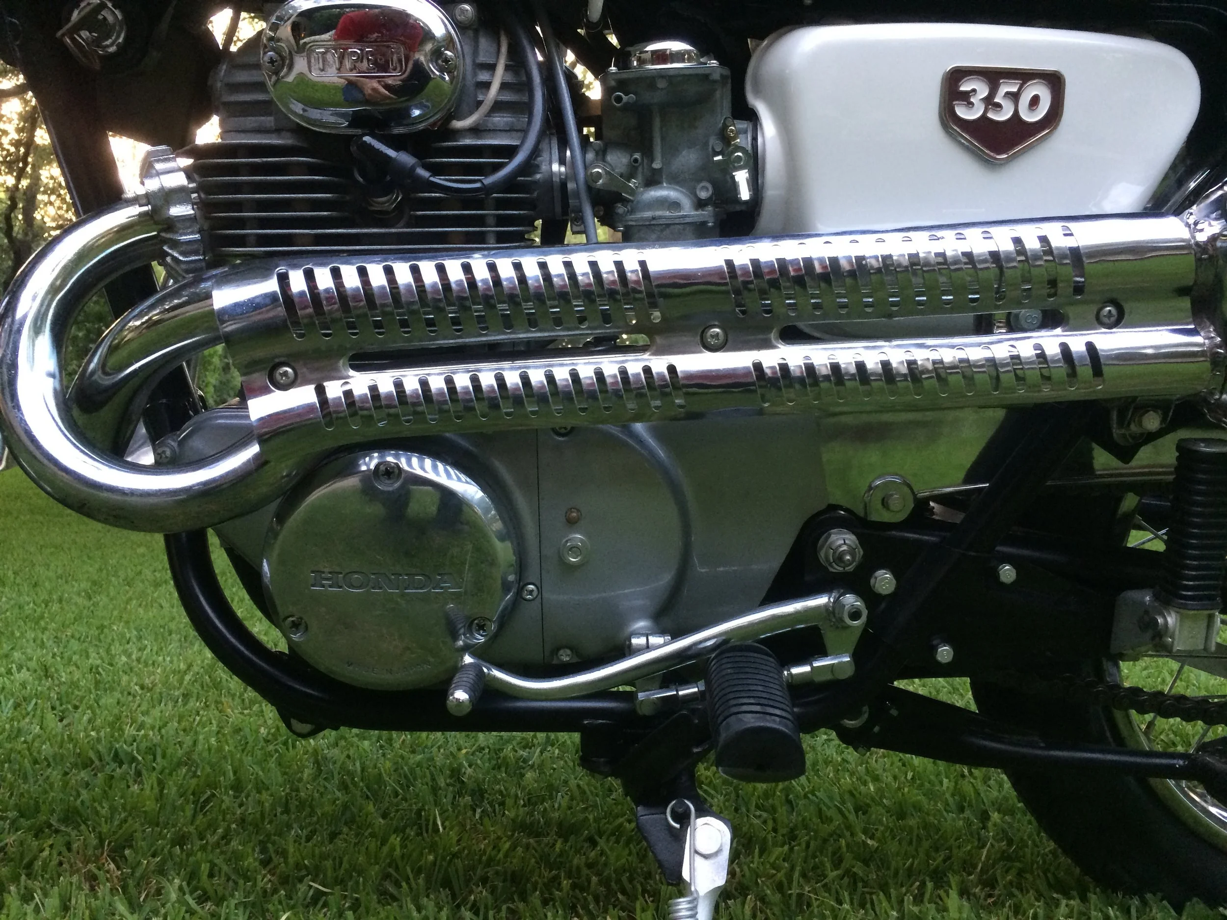  An NOS gear shifter and used linkage, a used muffler shield, and chrome re-plated points and carb covers. The original round engine side cover was polished and rest of the covers painted with Honda Cloud Silver paint. Carbs were dismantled and hardw