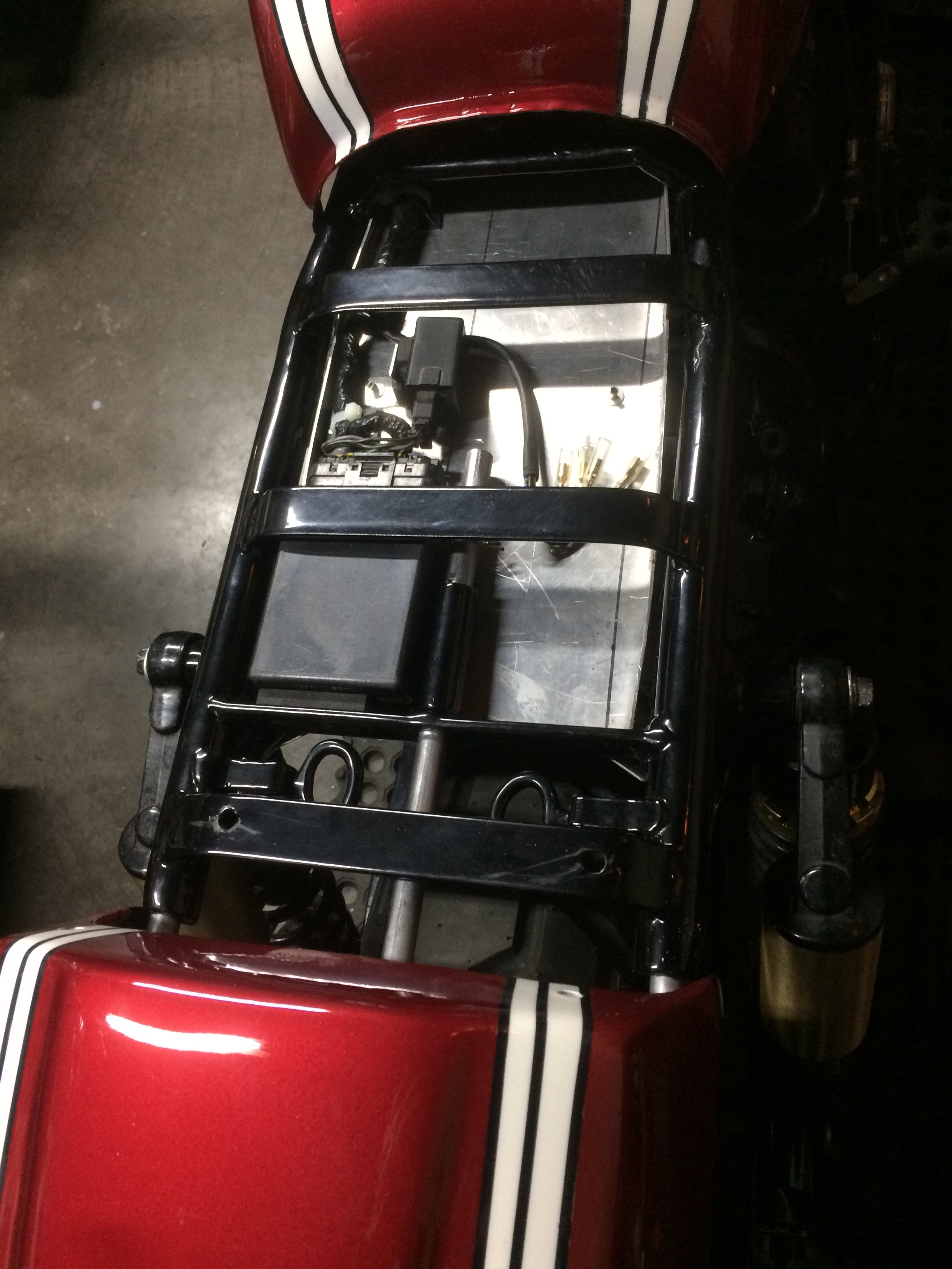  The seat extension mechanism and electronics pan. The two rings seen toward the bottom of the picture are accessible underneath the seat, and when squeezed together, release the sliding rear cover. The seat can be extended an extra two to six inches