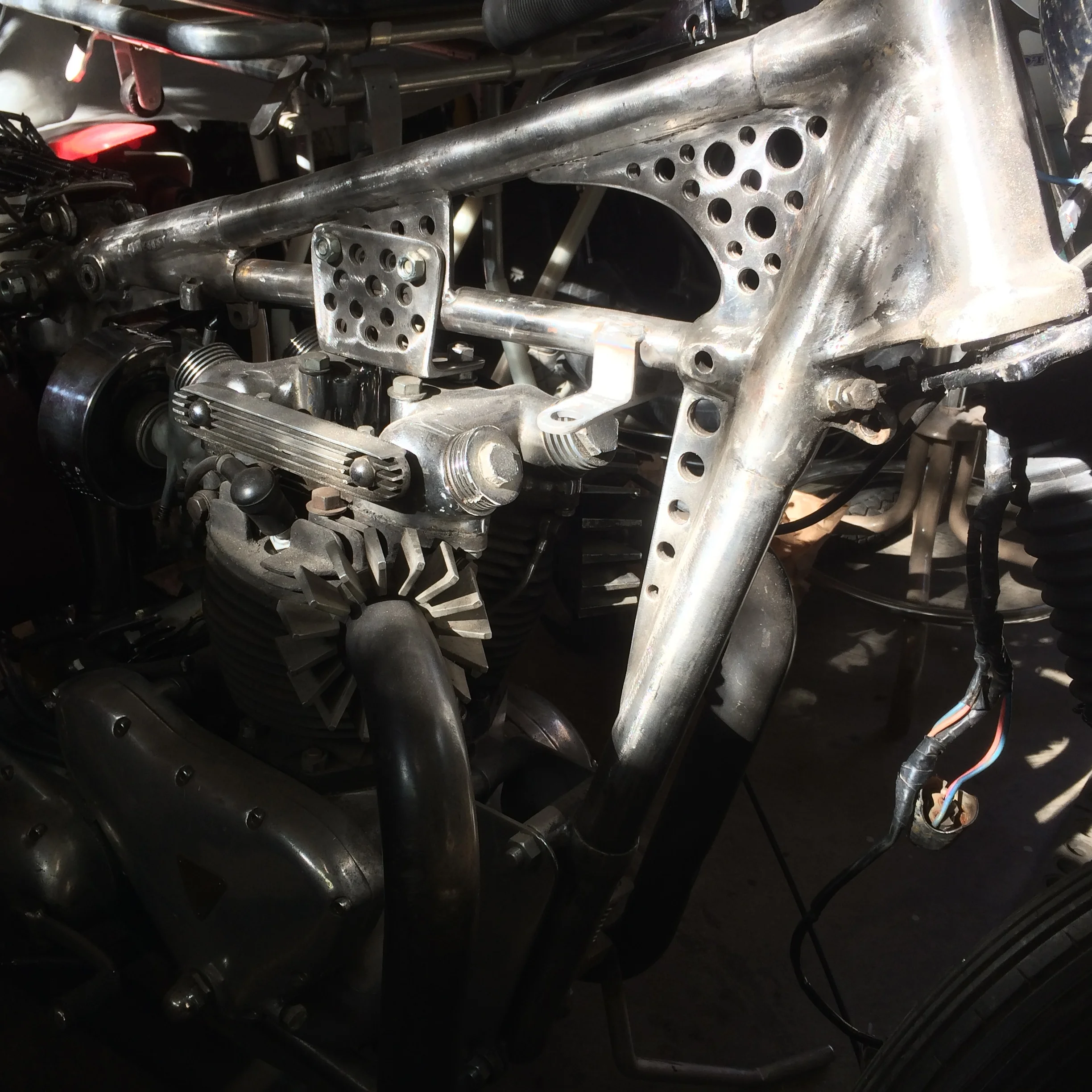  The previous owner had removed the lower top tube and installed a rather large gusset in its place on the front and back down tubes. A new tube was grafted in from a donor frame and the gusset cut down and drilled out. Another gusset was added below