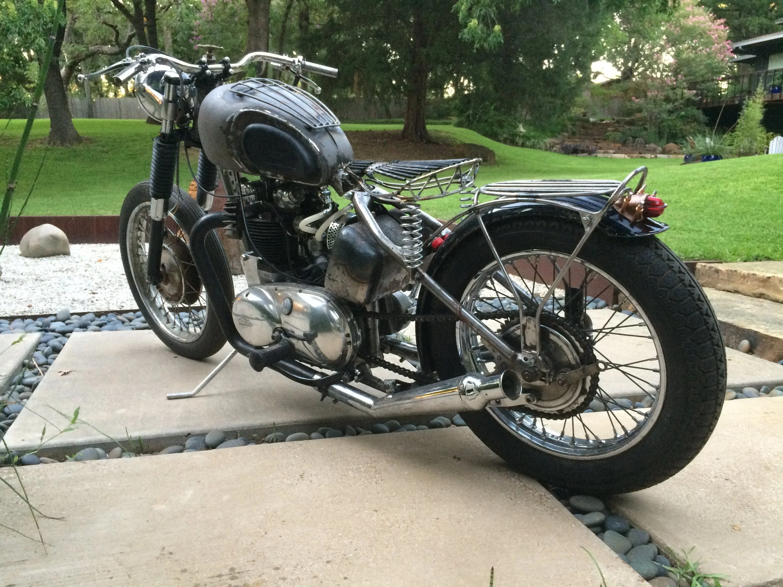  Here in mock-up a couple years ago, the tins have since been worked over and are in primer now. The brake light is made from a bronze cymbal, with an unknown glass lens. 