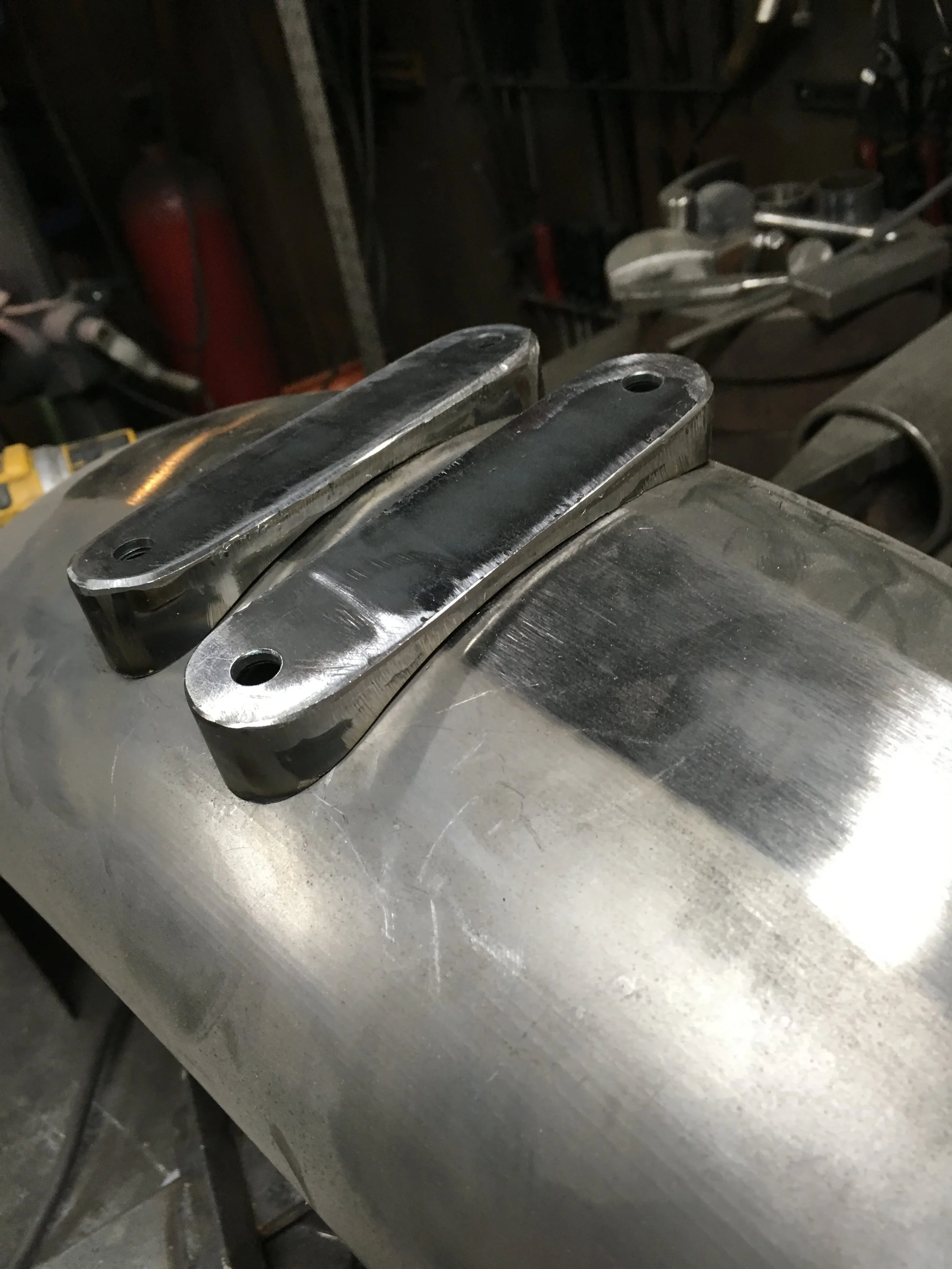 Some mounting brackets for the 1993 Harley-Davidson FXR rear fender, made from 1/8” plate and 16 gauge sheet steel. Capture nuts were welded to the backside to simplify installation.