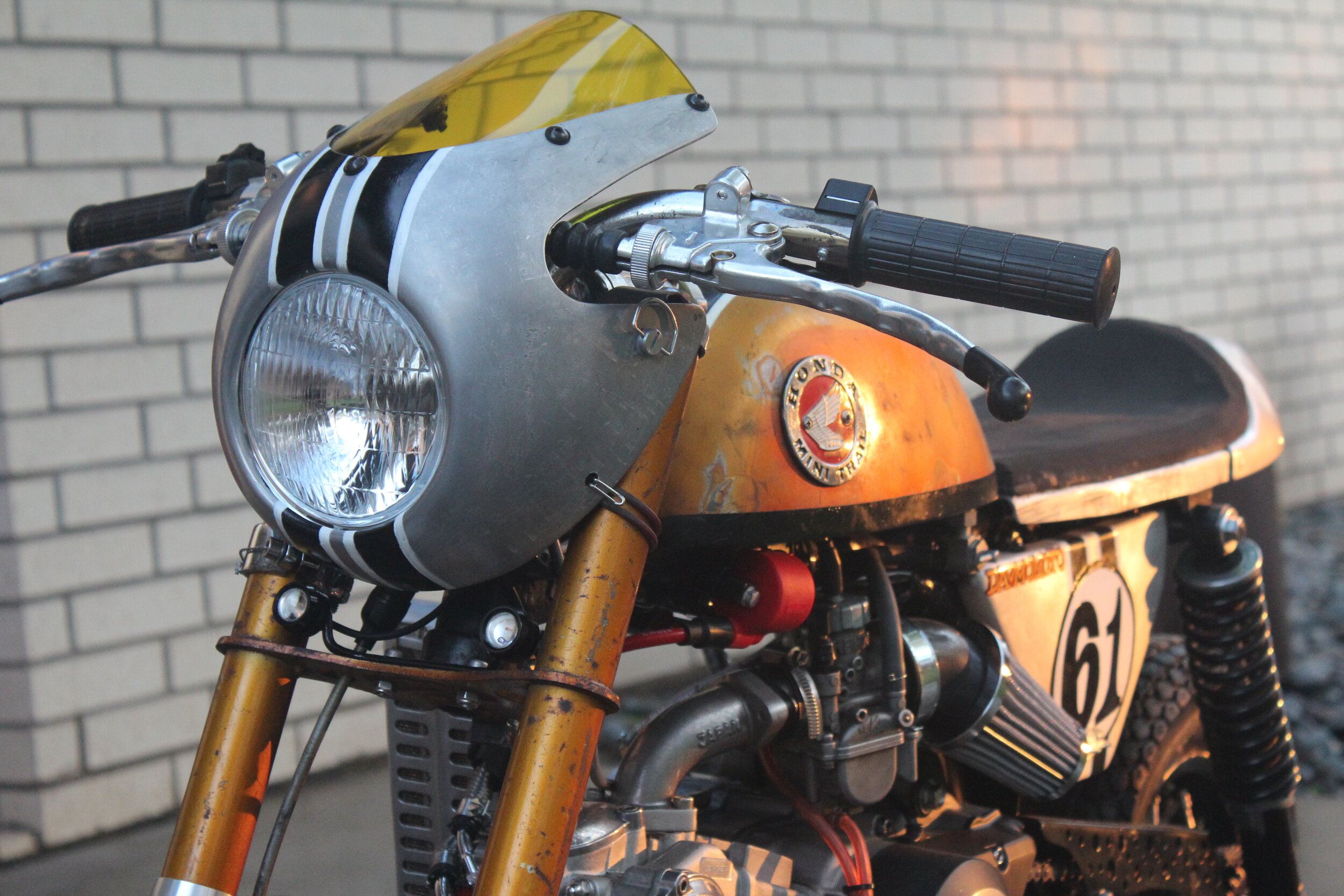  The quarter-turn fasteners that secure the front fairing can be seen below the handlebars, along with some rubber tethers and hooks. Some discrete turn signals are below the fairing. 