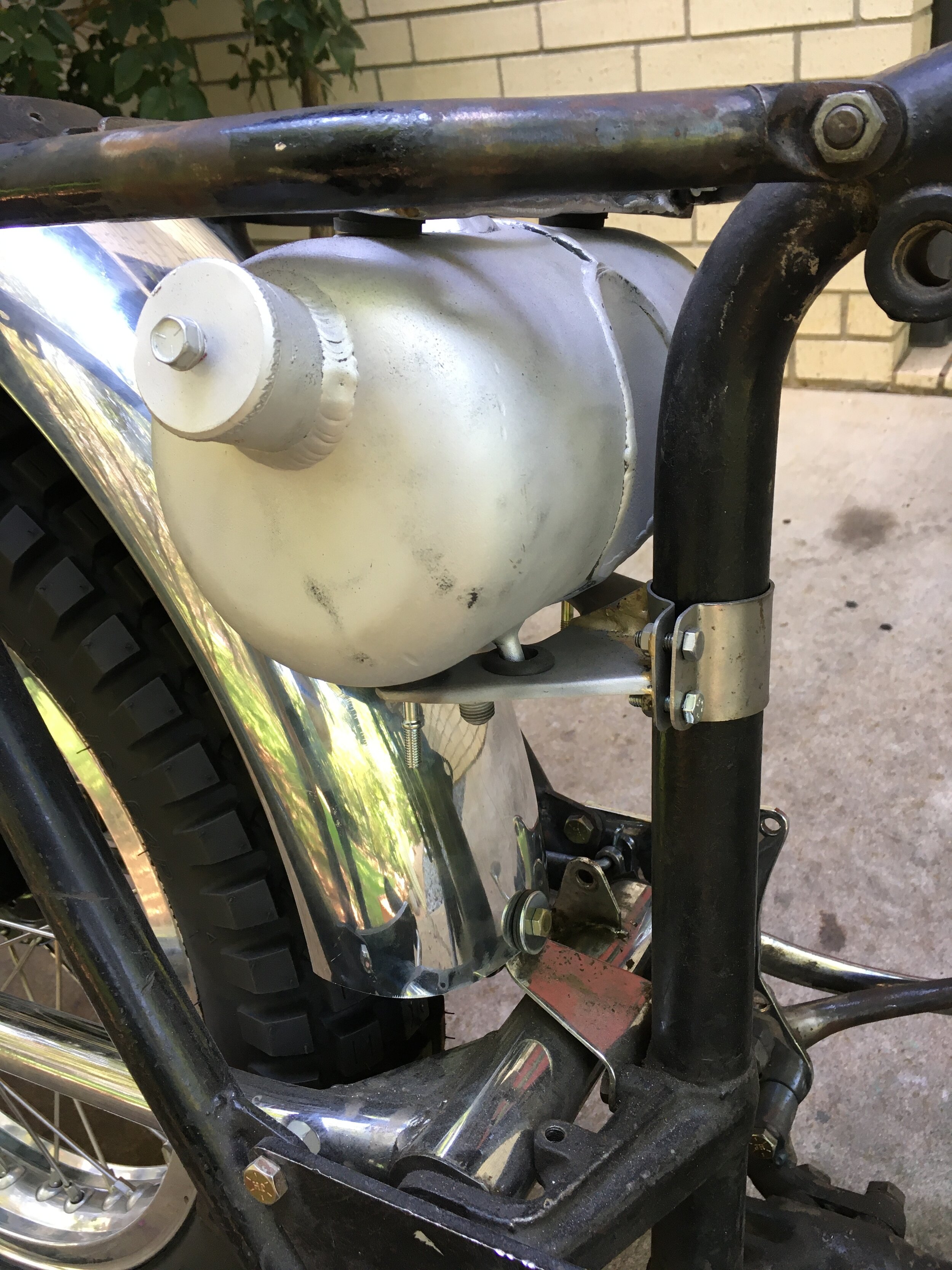  A custom oil tank mount that is rubber isolated top and bottom. 