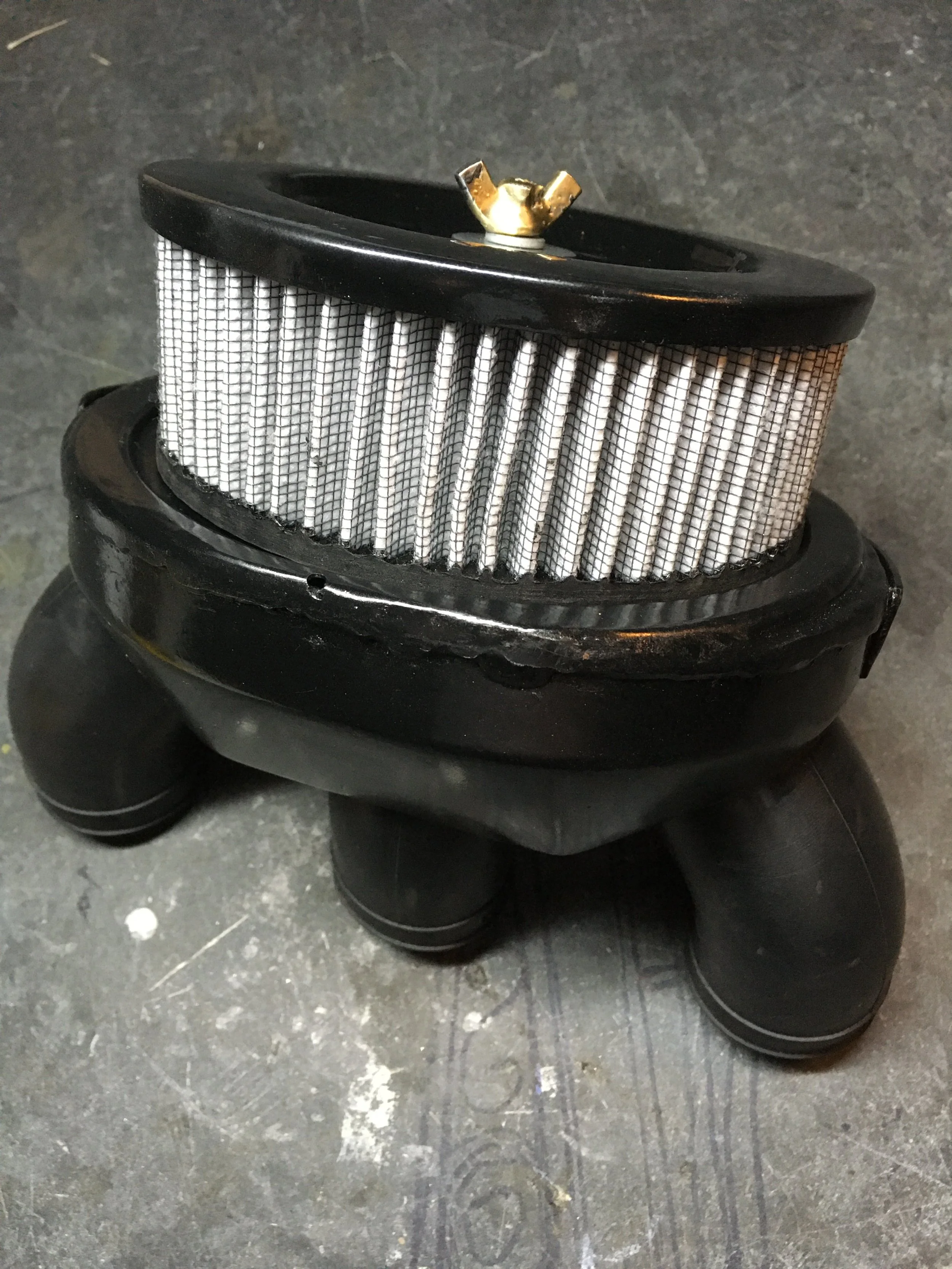  Oddly enough, I had the correct original airbox in my spares. A custom cap was made, as that part was missing. This assembly was later stuffed inside a custom box made from the original oil tank, and battery box. 