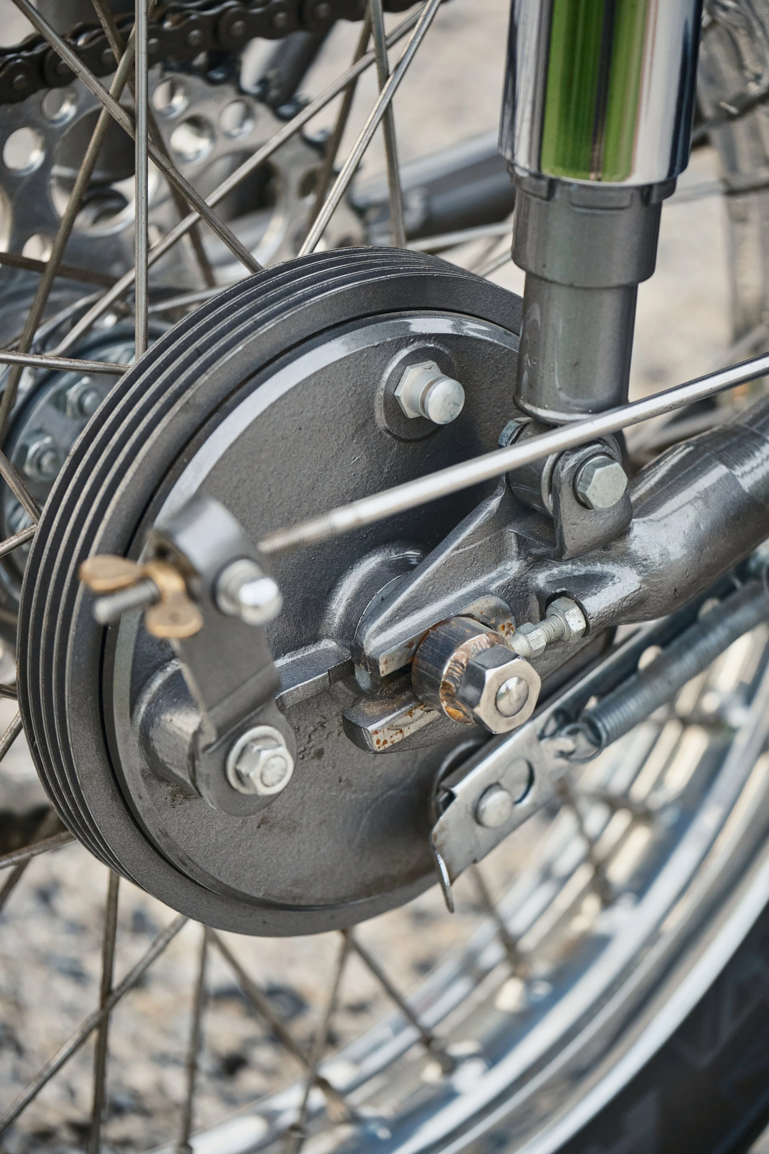  The Vincent Black Lightning rear wheel hub, brake and brake stay. One of the wonderful things about Vincent design, the brake stay can be removed from the hub quickly, sans tools. Rear loops were added to the frame to mount passenger pegs. 