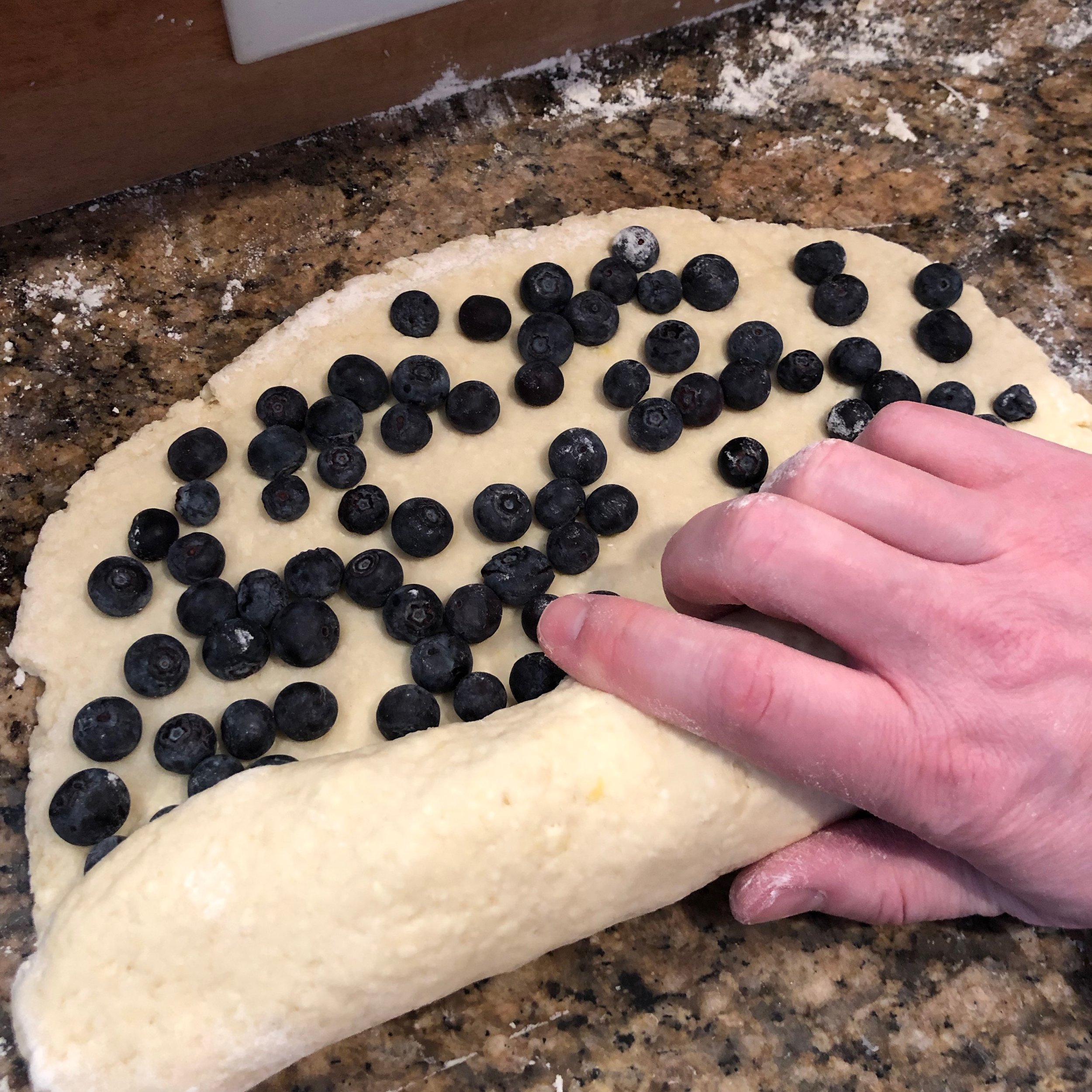  Rolling the blueberries into a tight log. 