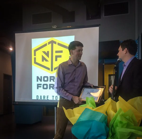 Craig Milligan (left) receiving the graduation certificate from Eureka Project mentor Christian Dandeneau of ID Fusion (right).