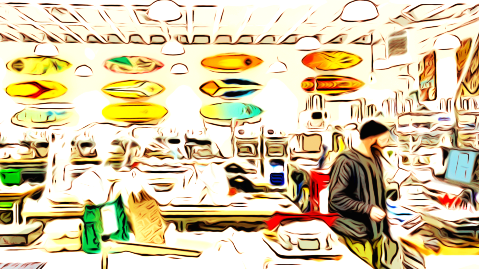 Colorful surfboards displayed on the wall of a retail store, with a customer shopping.