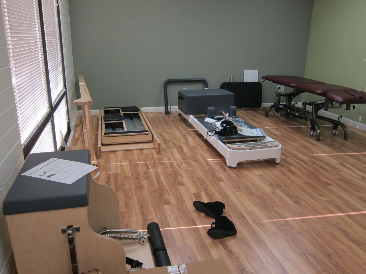 Pilates equipment came in! The guys that delivered were so rough with everything. They were tossing boxes around (almost hit my daughter with a flying box), dropped some stuf,f scuffed my wall, and almost fell. It was scary to watch. We were lucky that we were able to meet them too. They were supposed to come between 8:30 and 1:30 .. of course they arrived at 1:45.
High-low table came in on the same day. I wasn’t going to get one but I found a good deal on a very, very gently used table. I had to just accept that it was going to be burgundy. I would have chosen grey. Oh well, at least it’s a color that matches.
Now it’s time to assemble everything. The brothers are coming this weekend to help me assemble the ikea furniture and all the pilates equipment.