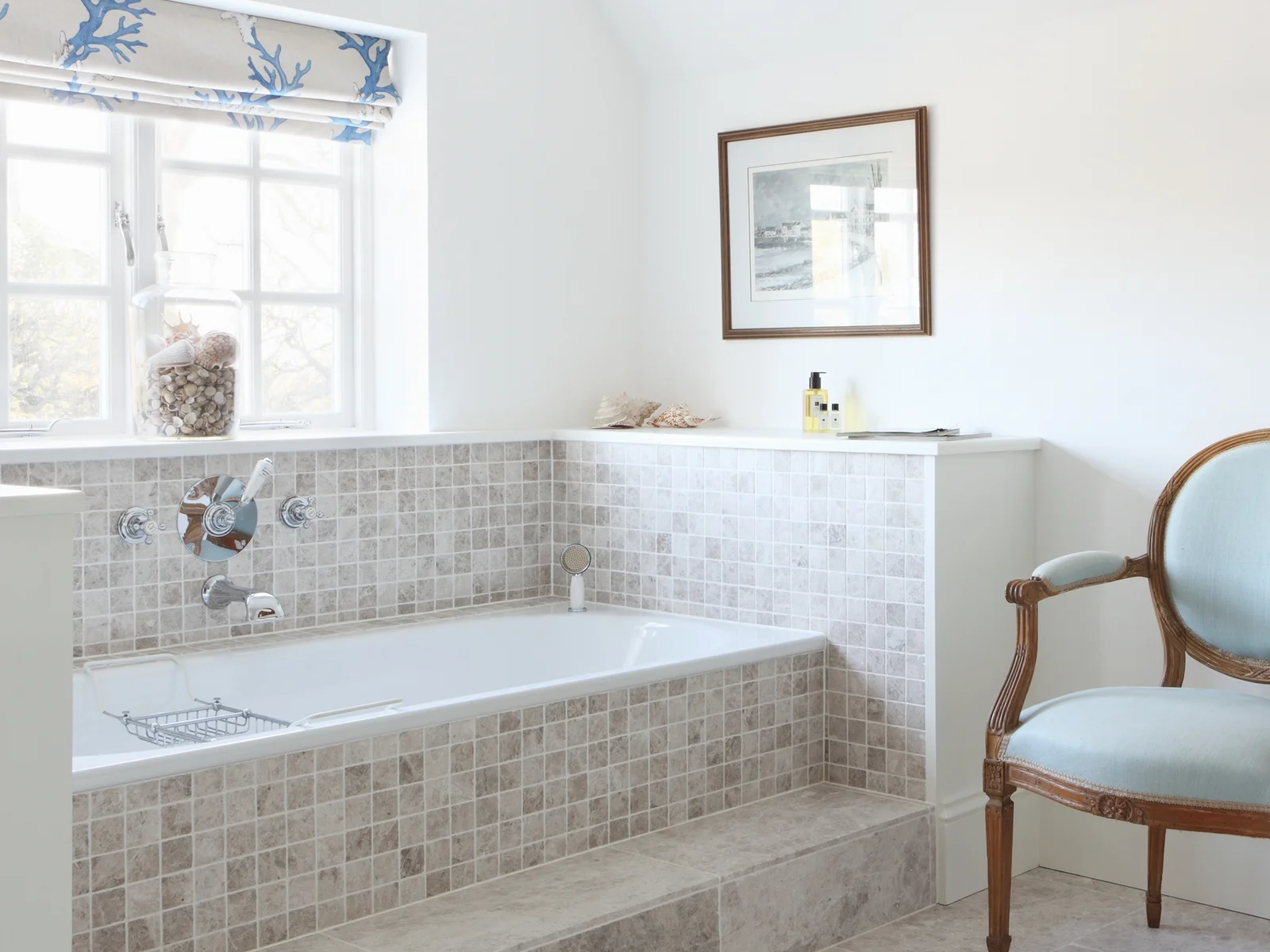 This is from our Turnkey project. We love the pale blue armchair and the seashells surrounding the bath. Click here to see the entire project .