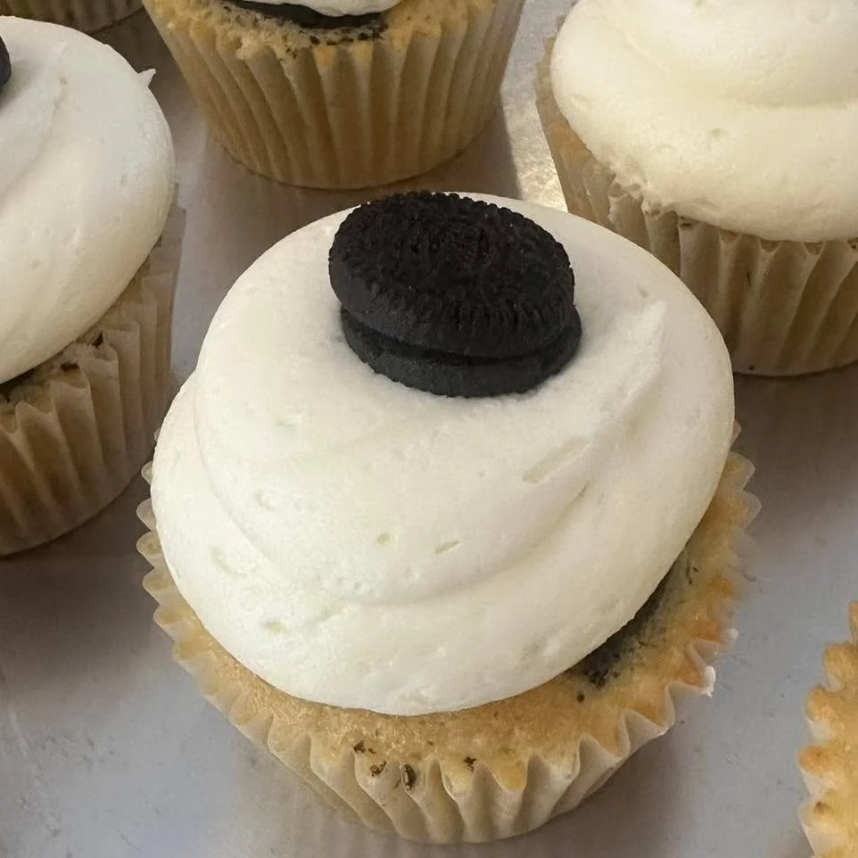 Oreo Explosion!  This cupcake is an Oreo lovers dream!  Oreo baked at the bottom of a vanilla cupcake with crushed Oreos inside, topped with a vanilla buttercream frosting and an Oreo on top!! 
One of the most popular flavors each week.

Menu-
Ding D