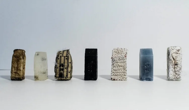 Filth Cast Materials - from left to right: coffee grounds & filters, soap & flies, fabric & stitching, wax & tar, copper & yarn, wax & dryer lint, paper pulp & hair 14 x 3 x 1 in. 2015