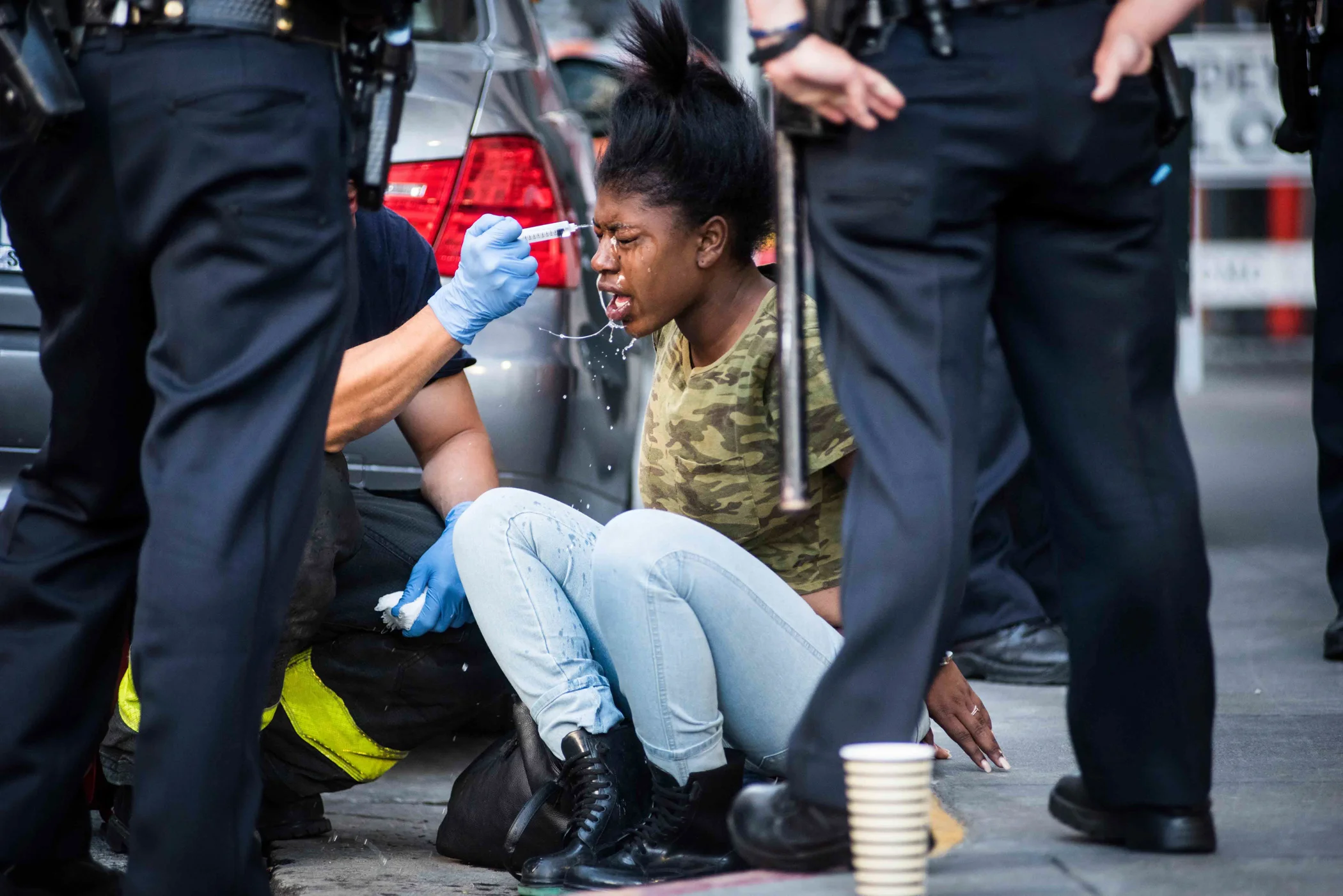 An alleged shoplifter is treated by San Francisco paramedics after being pepper sprayed by a police officer during a fight outside of a Union Square retailer on Tuesday, June 23, 2015. (Michael Ares / Special to the S.F. Examiner) 
