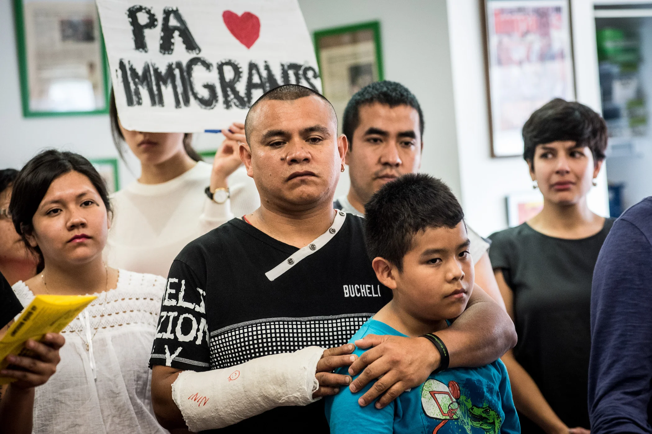 Carlos Rojas holds son Michael, 11, during a news conference in Philadelphia at which activists and immigrants voiced their opinions on the 4-4 Supreme Court ruling on Thursday, June 23, 2016. As an unauthorized immigrant Rojas was affected by the Supreme Court's decision on the Deferred Action for Parents of Americans program which protected him from deportation and allowed him to work legally. (Michael Ares / Philadelphia Inquirer)
