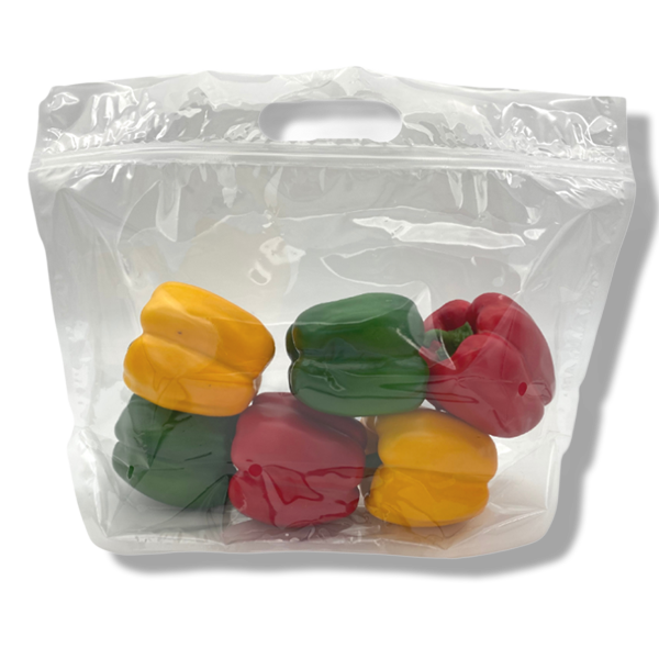 peppers in yellow, green, and red inside a clear zip lock plastic bag.