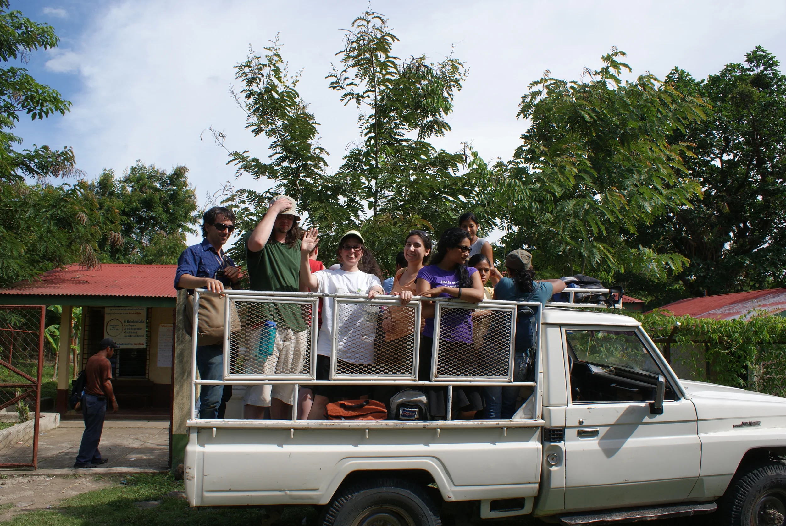 Students riding in truck to rural clinic.