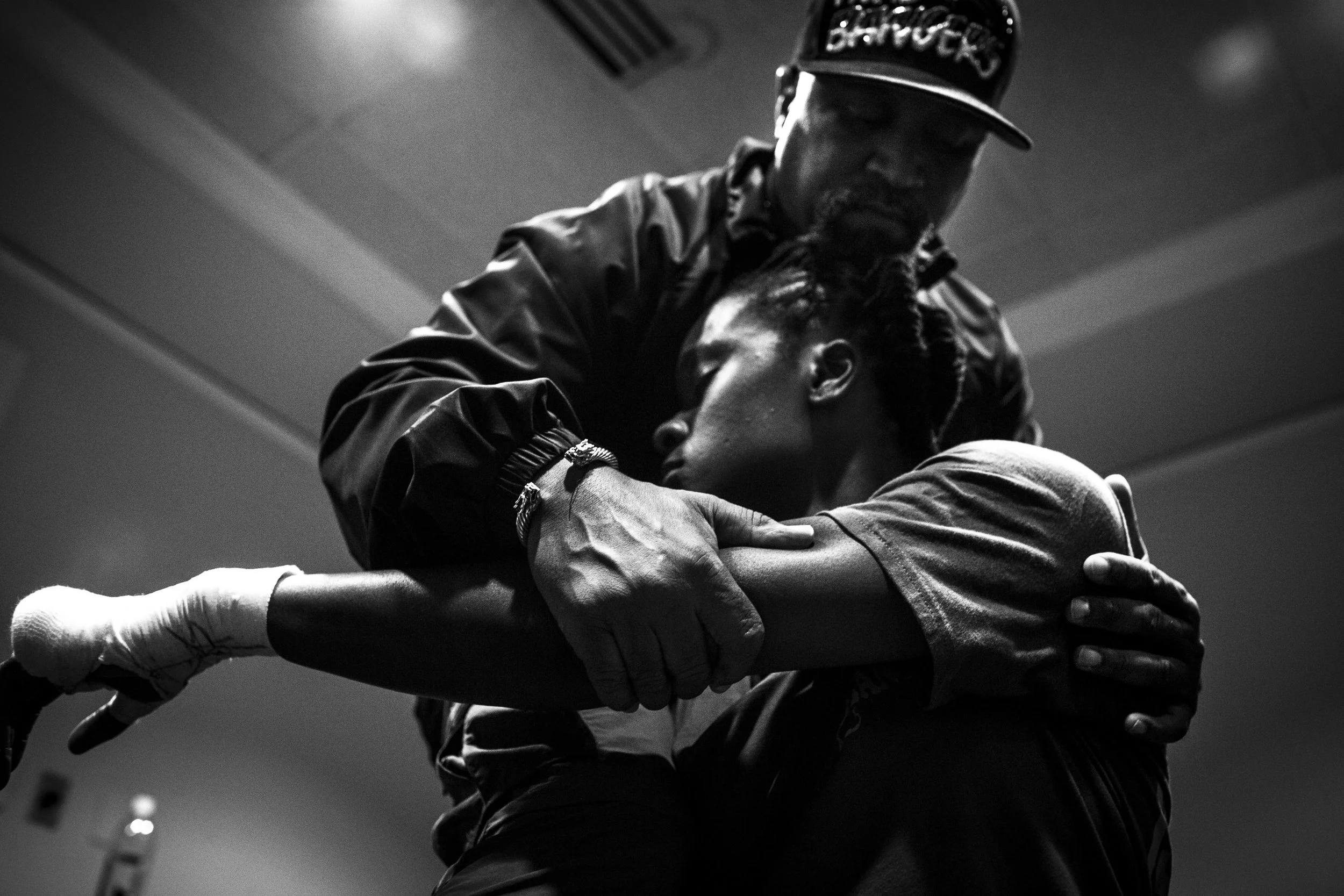 Coach Jeff helps Tiara stretch before her professional debut fight. 