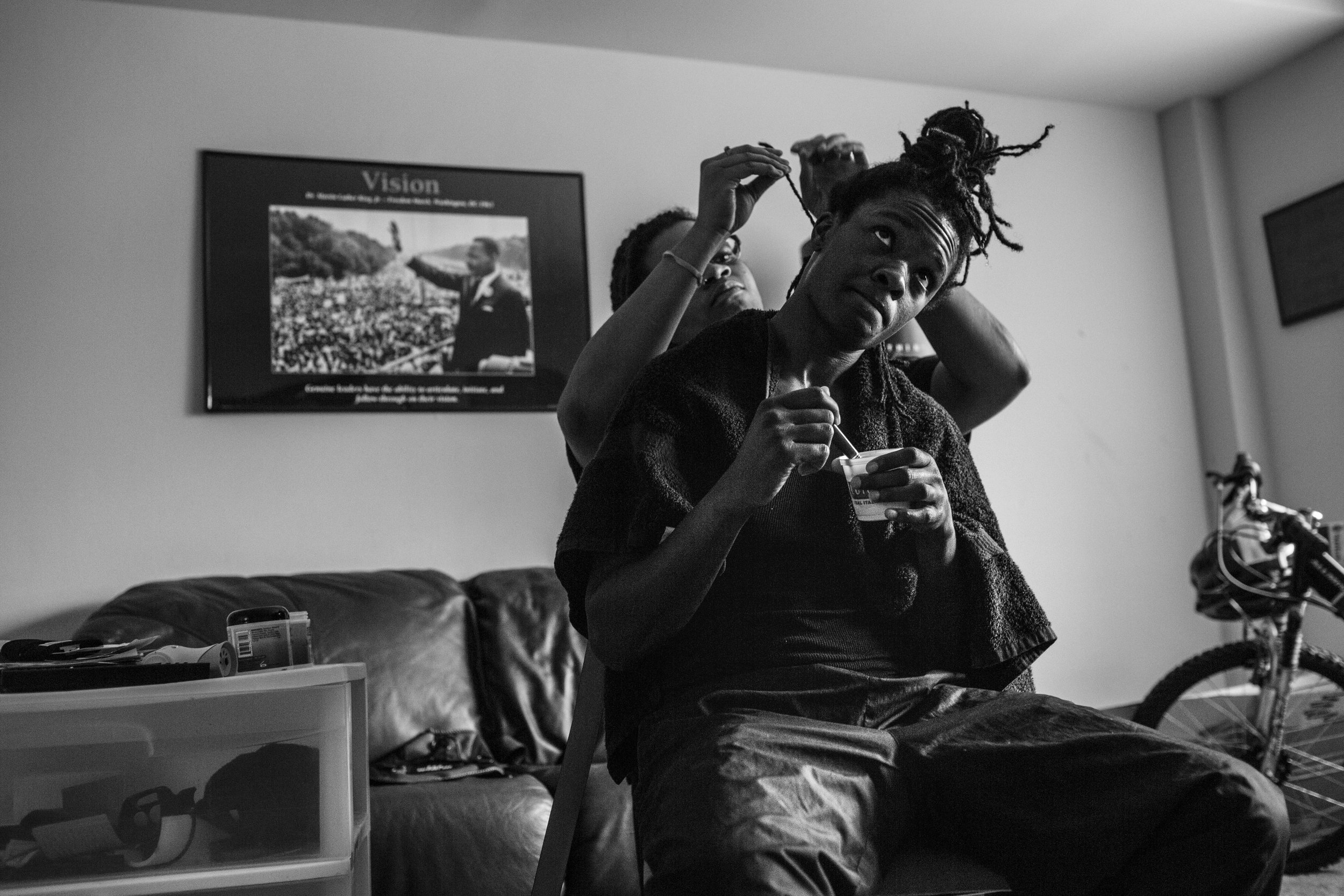   Tiara gets her hair braided at home, days before a fight at the Howard Theatre.  