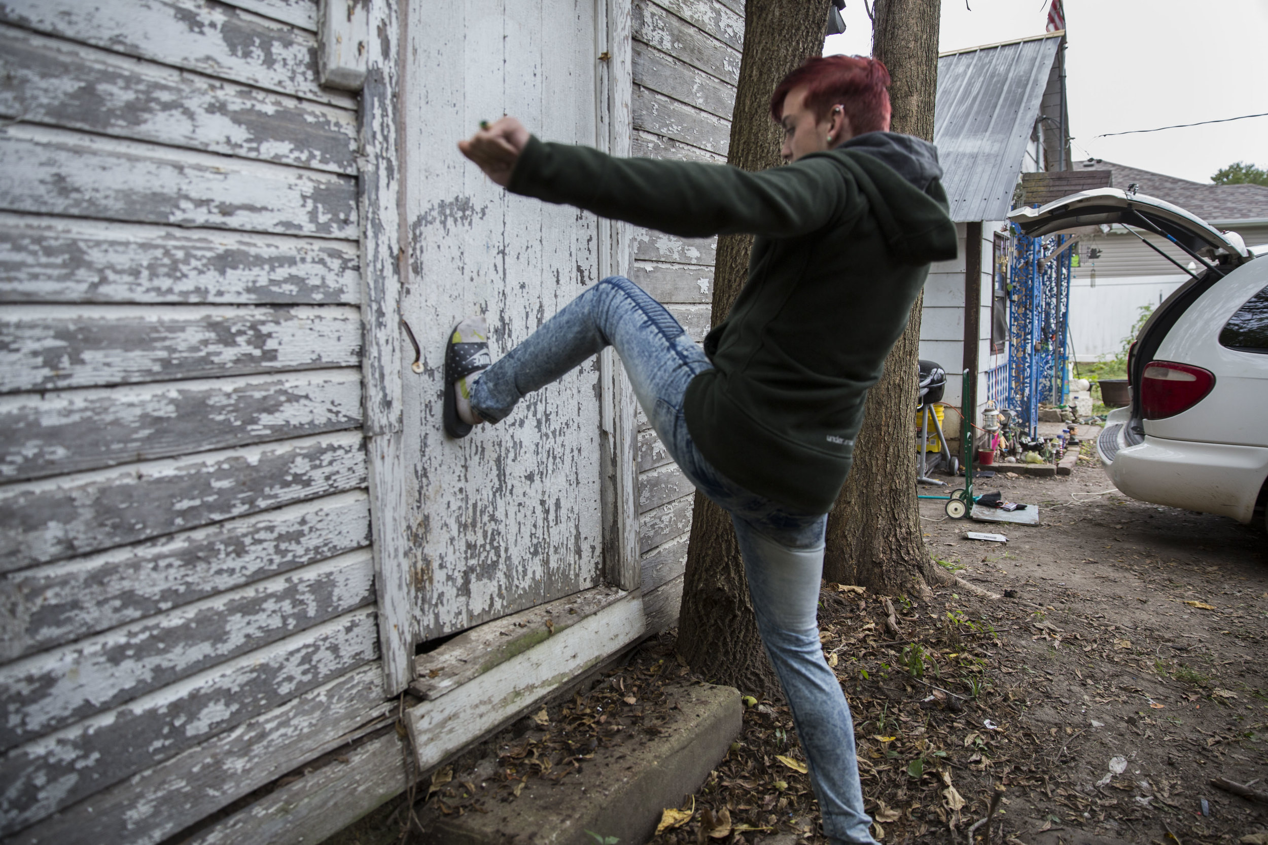   Billy kicks the door of an abandoned house next to Chris’ home. These houses are often used by addicts as shelter to get high in.  