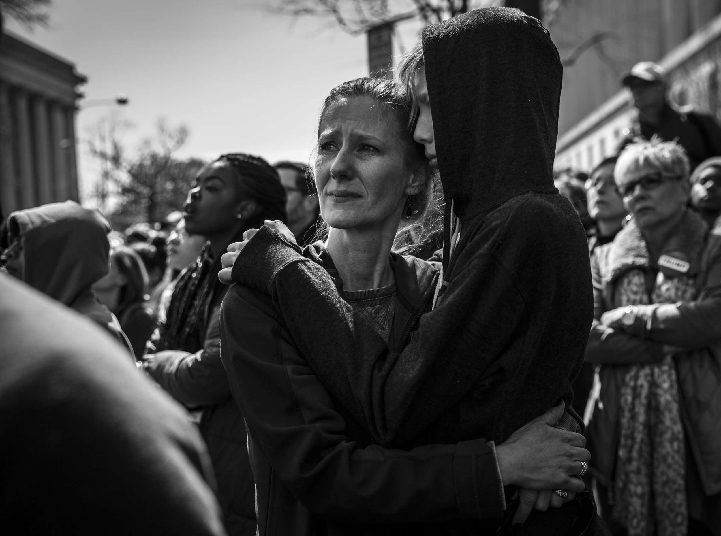   A woman embraces a child during the March For Our Lives in Washington, DC.  