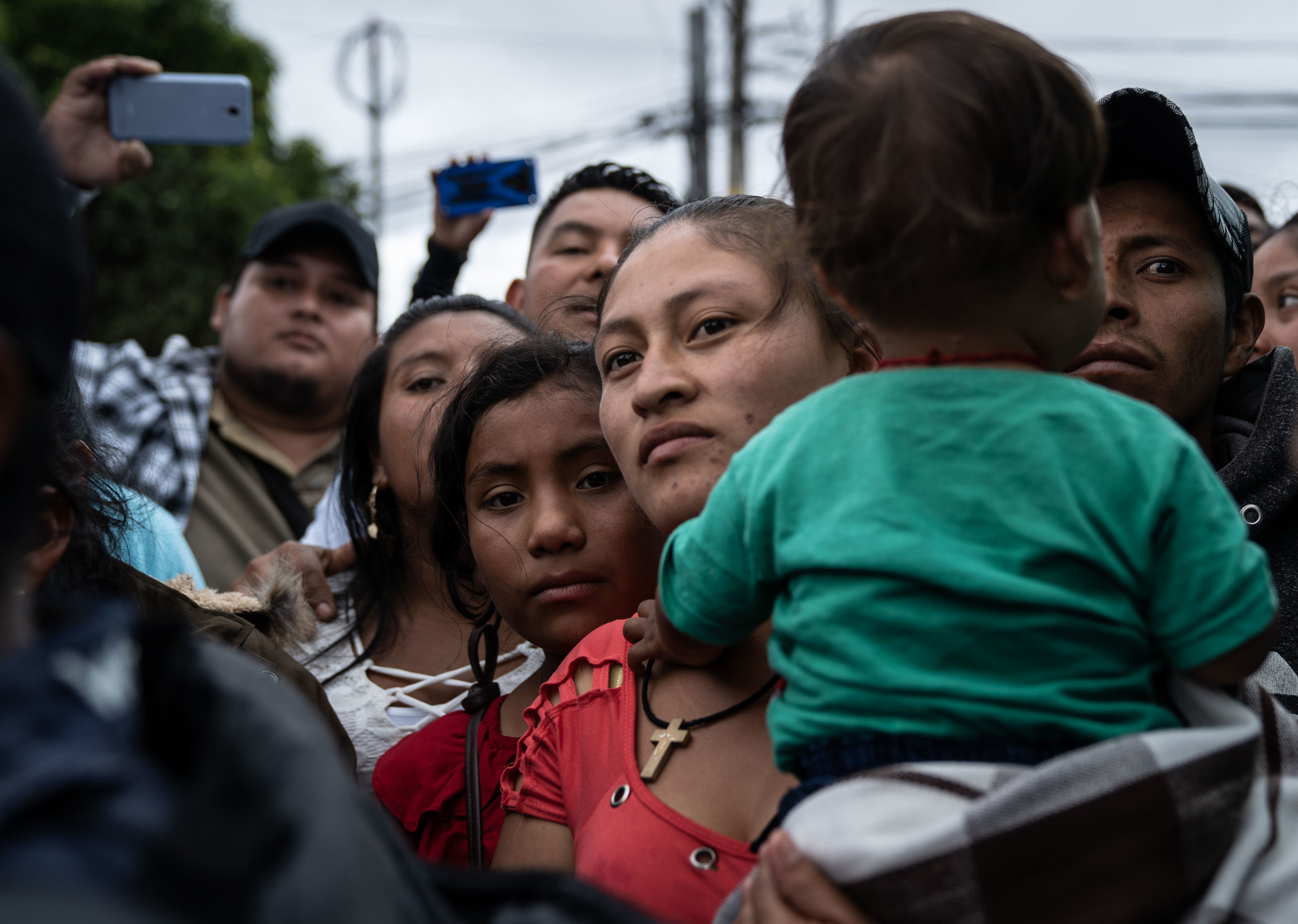   Family members and loved ones wait for deportees to exit a Repatriation Center in Guatemala City in May, 2019.  