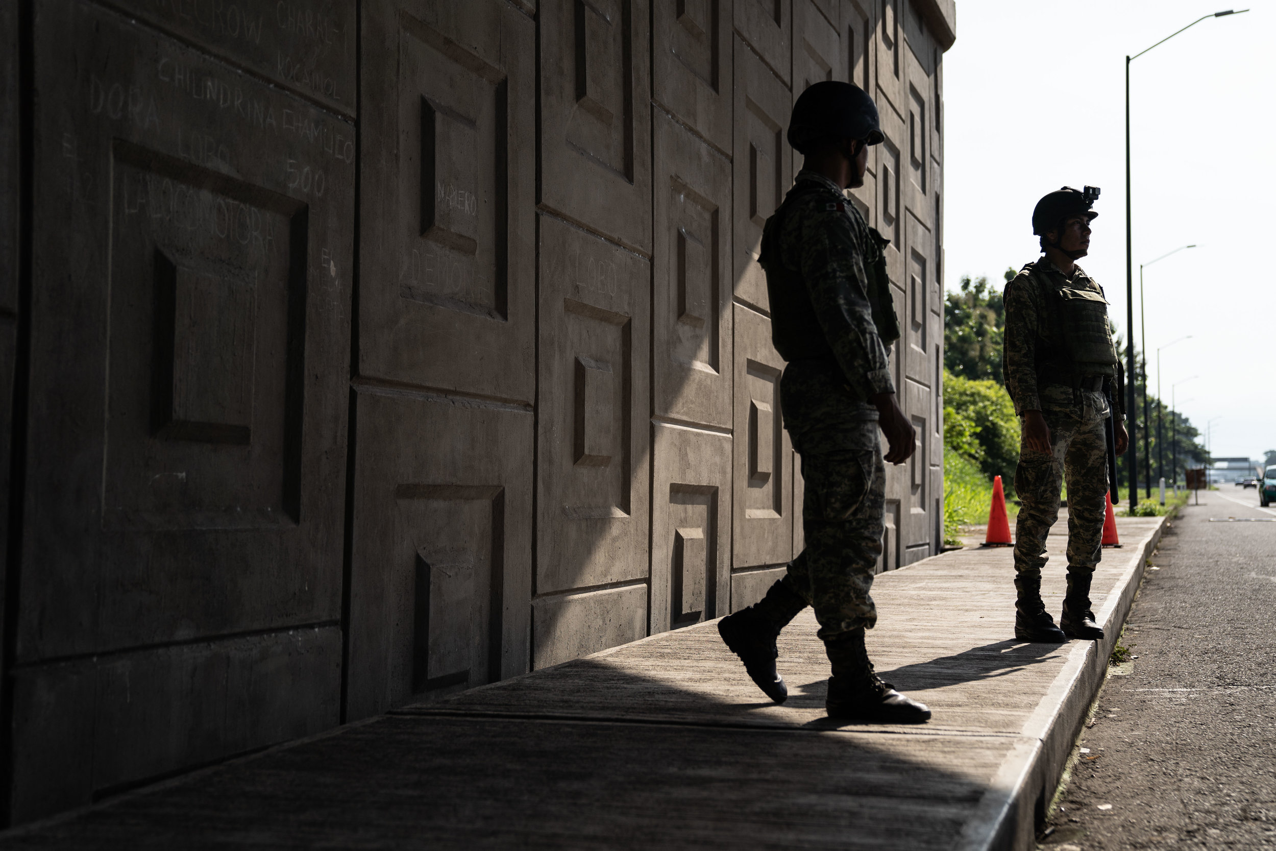   Members of the National Guard stand at a checkpoint on a highway in Tapachula, Mexico on June, 2019.   