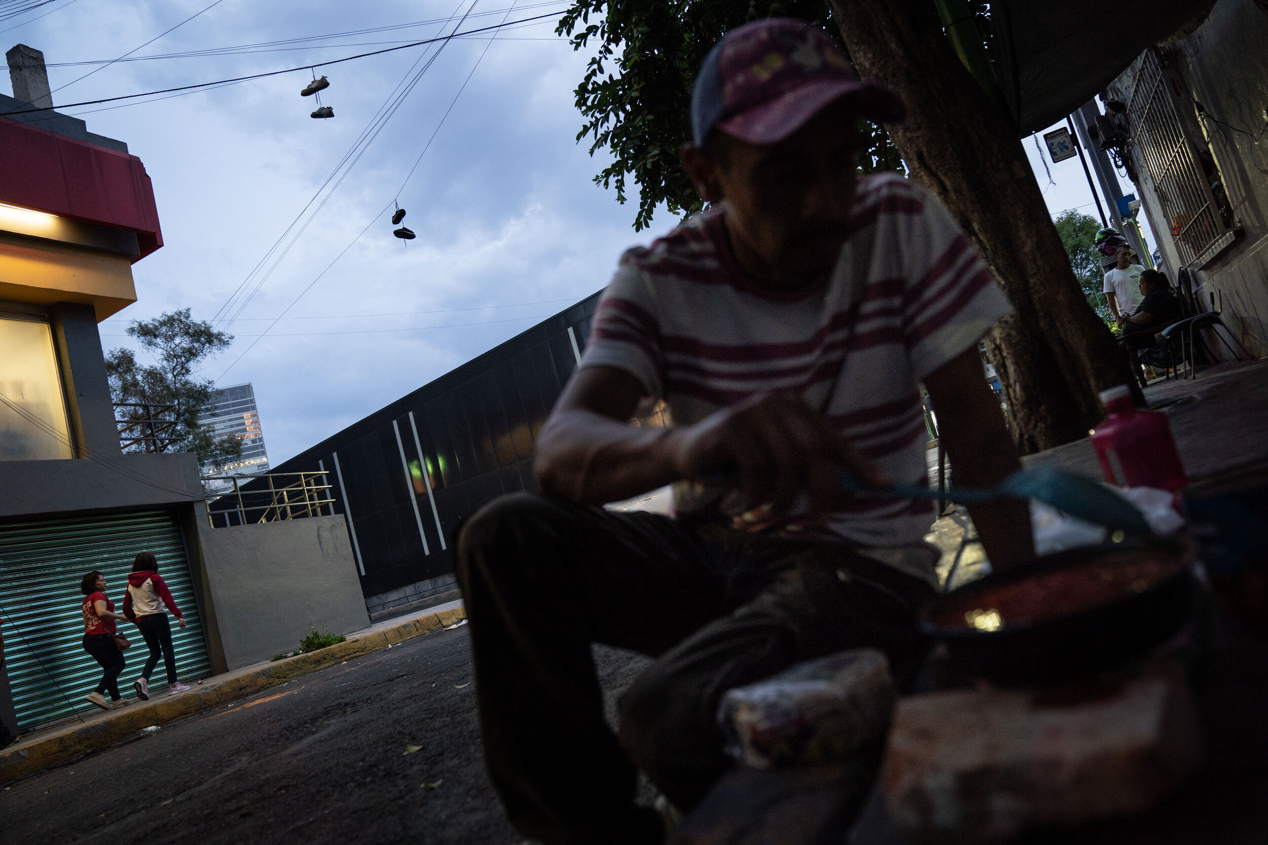   Juan prepares a meal on the sidewalk in the Buenavista neighborhood.  