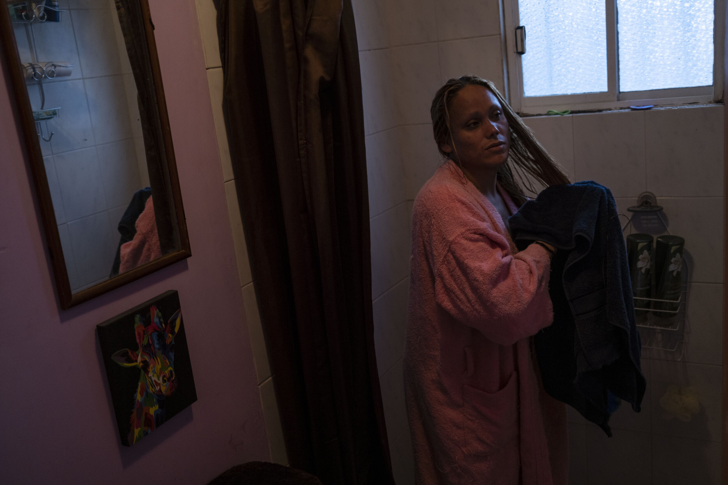   Nicky dries her hair in her new home in Chalco, State of Mexico.  