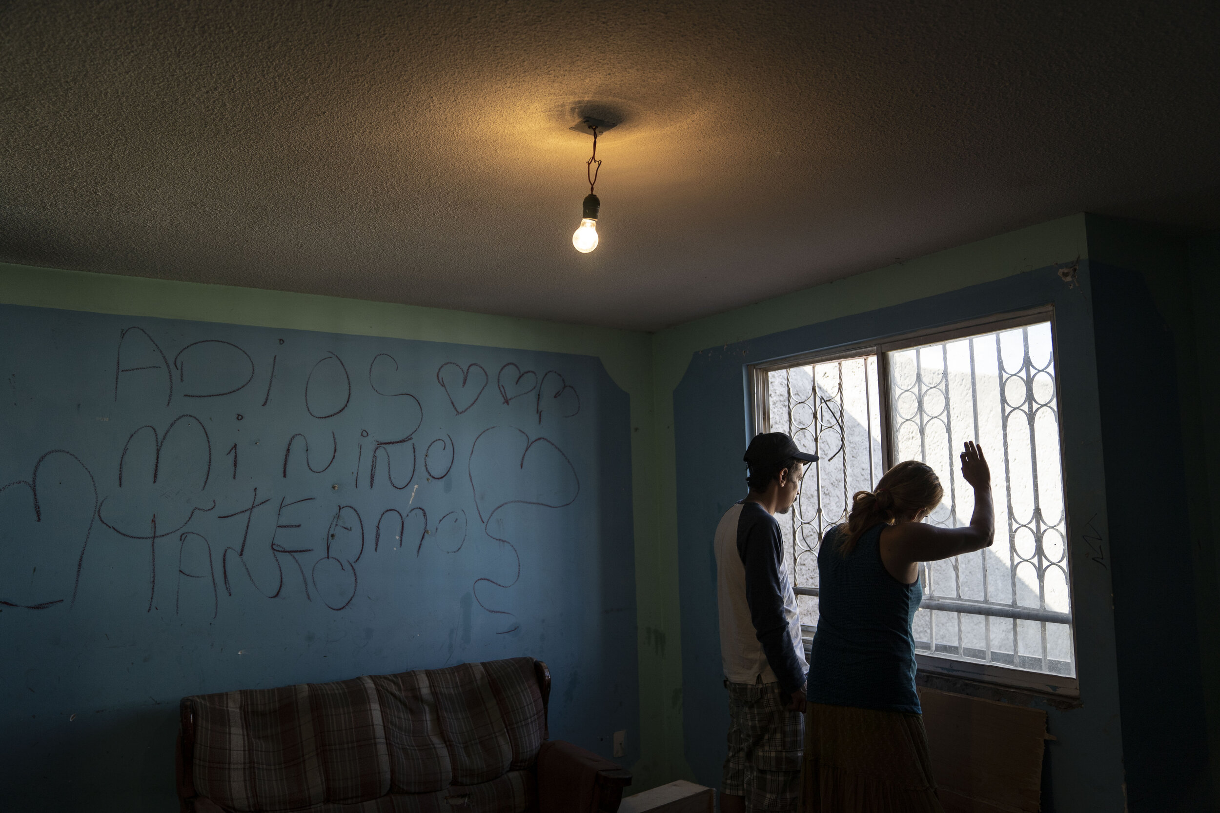   Nicky and Juan look out the window of their new home in Chalco, State of Mexico.  