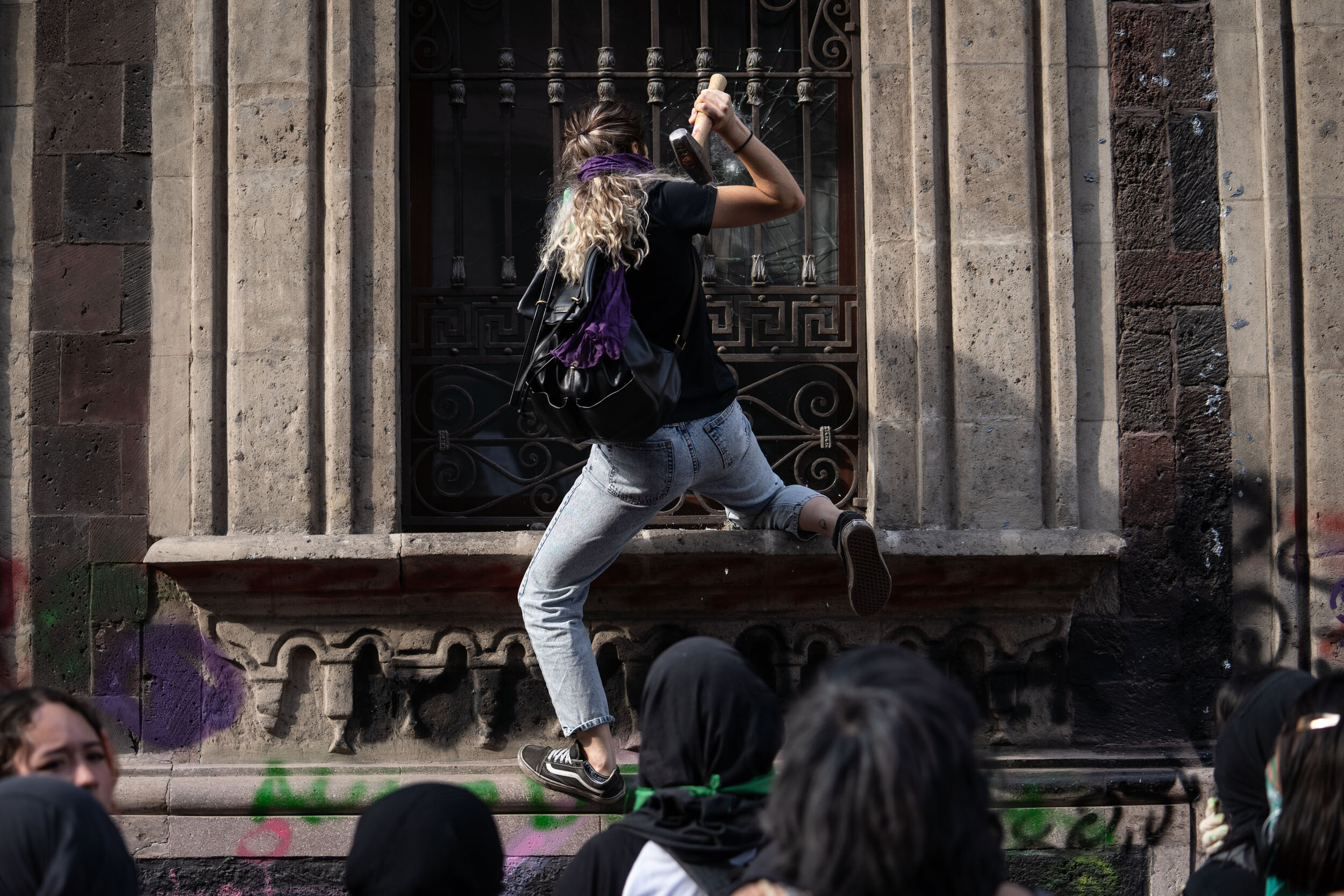   A protester breaks a window during International Women’s day, Mexico City  