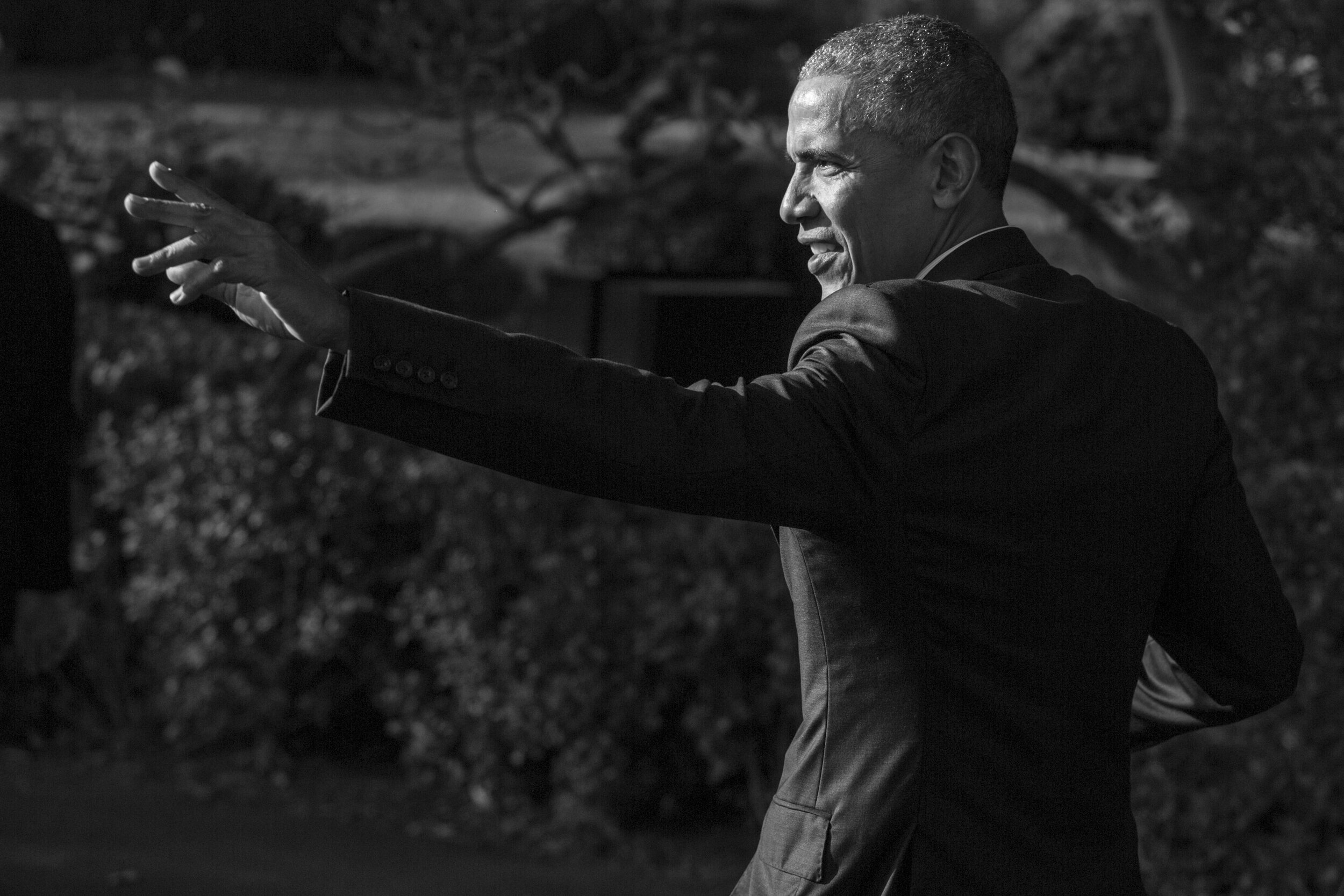   President Obama waves to guests at the White House  