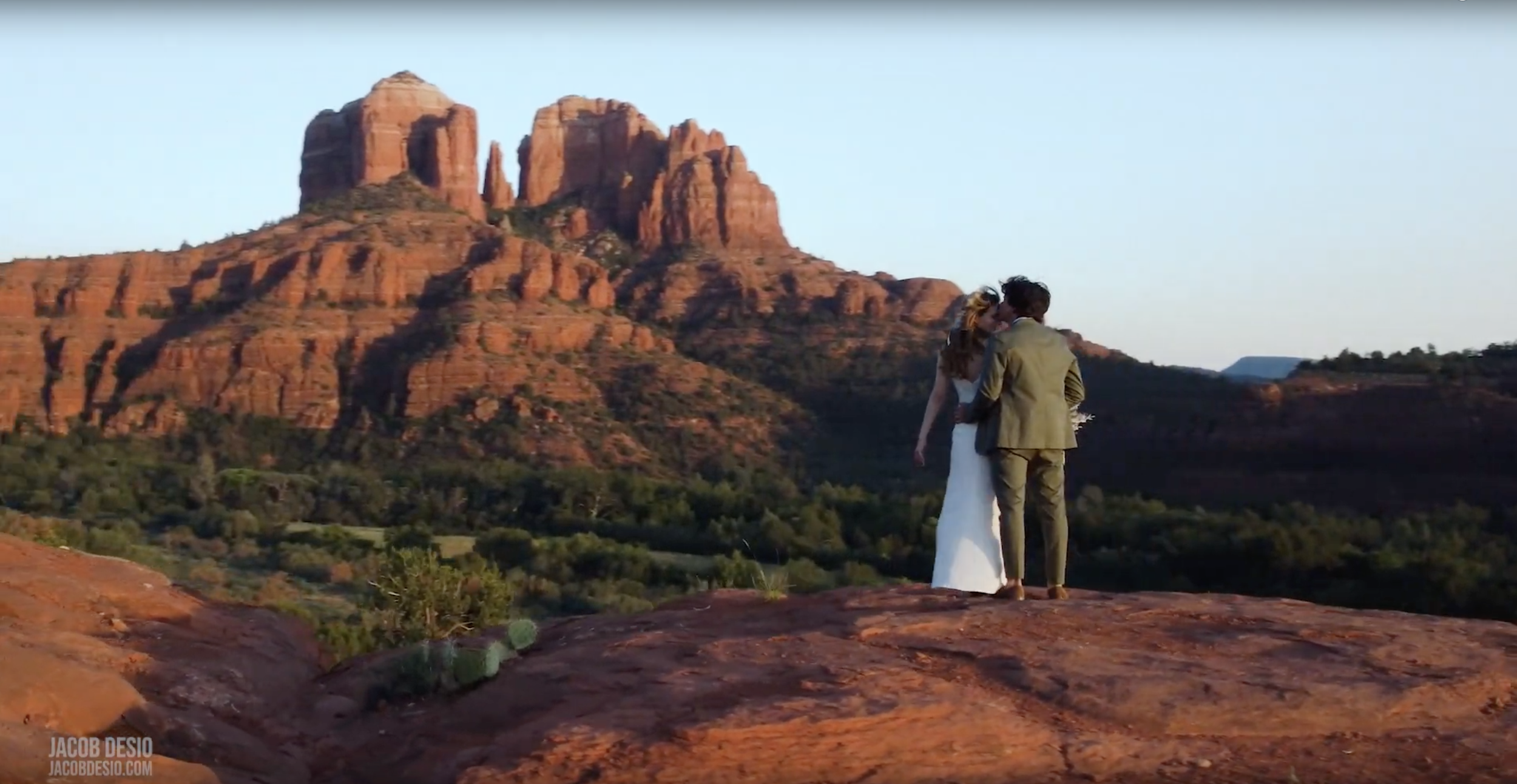 wedding couple on edge of cliff.png