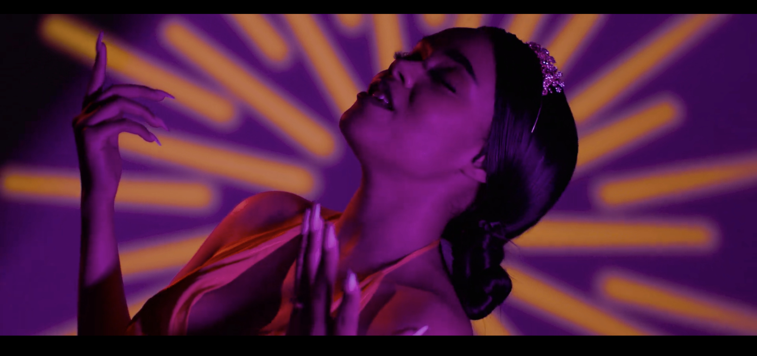 music artist singing with purple and yellow designs.png